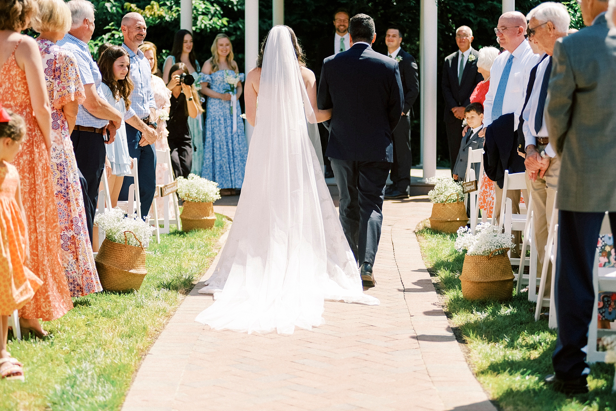 father escorts bride down aisle for garden ceremony at Kate Edri
