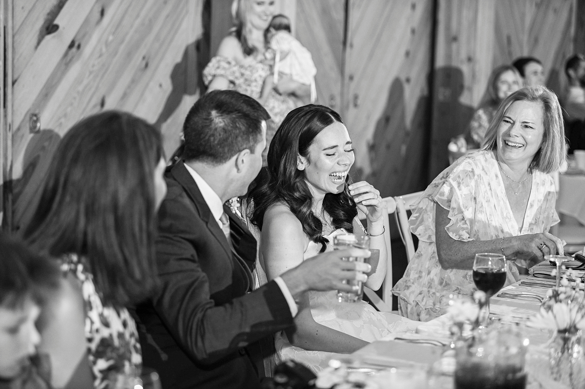 bride and groom laugh during toasts at Charlotte NC reception
