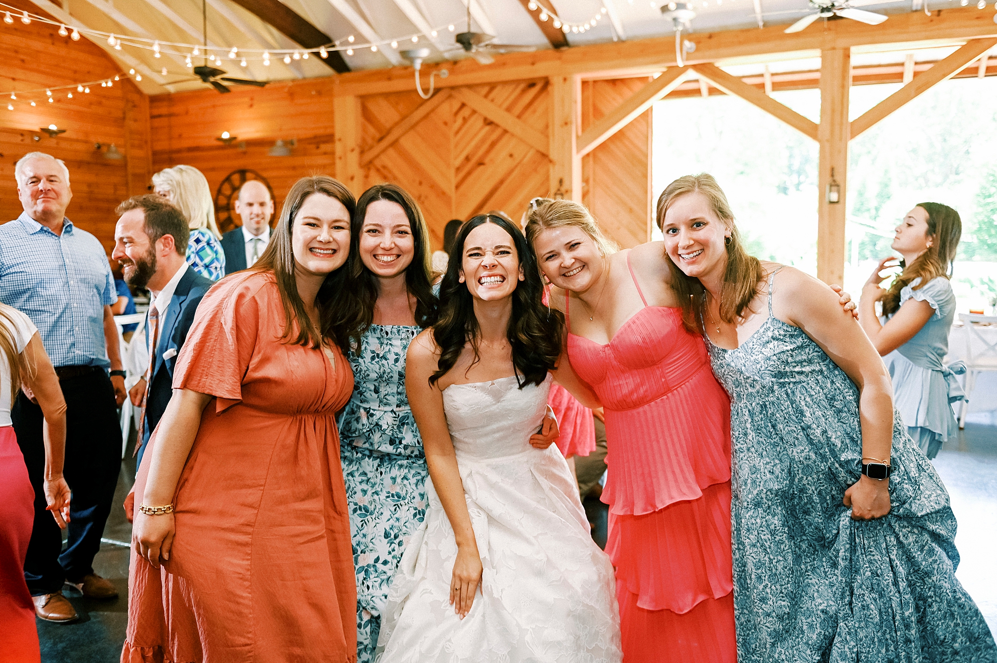 bride smiles with four women on dance floor at Alexander Homestead