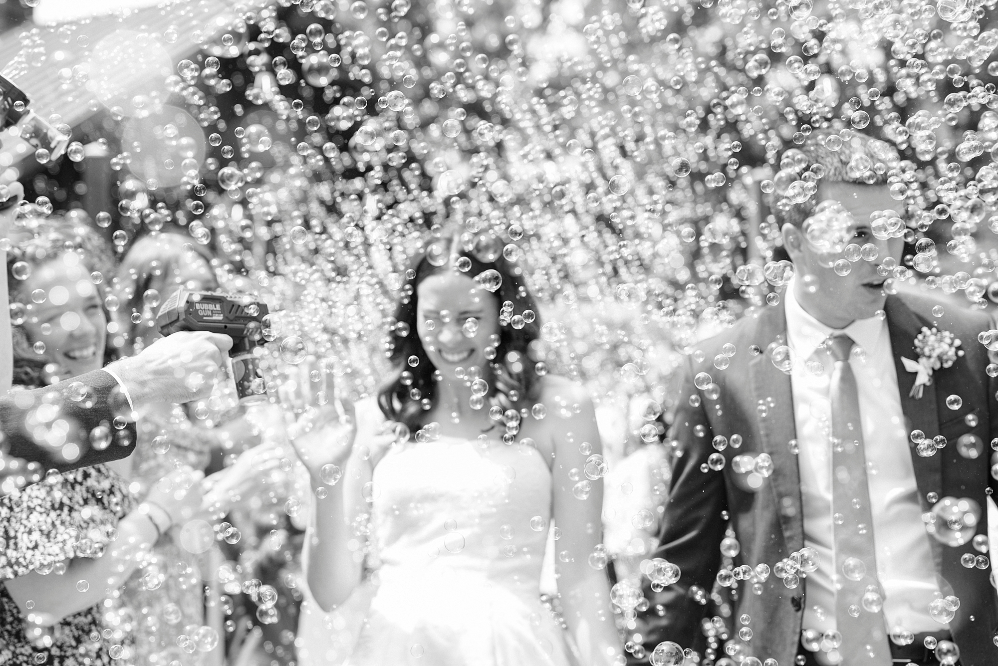 bride laughs with bubbles around her at Alexander Homestead