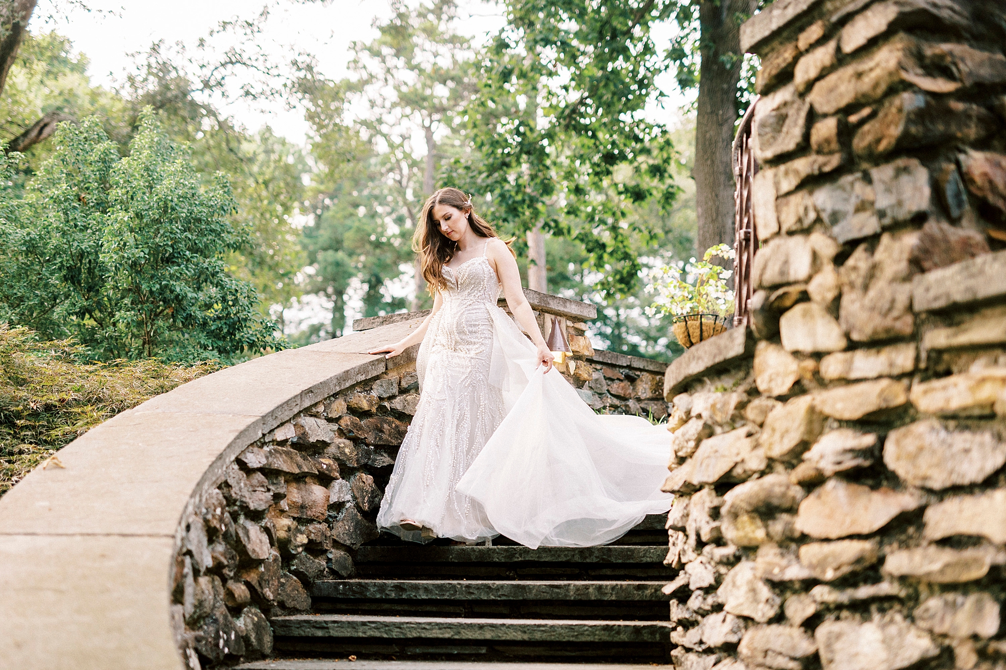bride walks down staircase at the Graylyn Estate