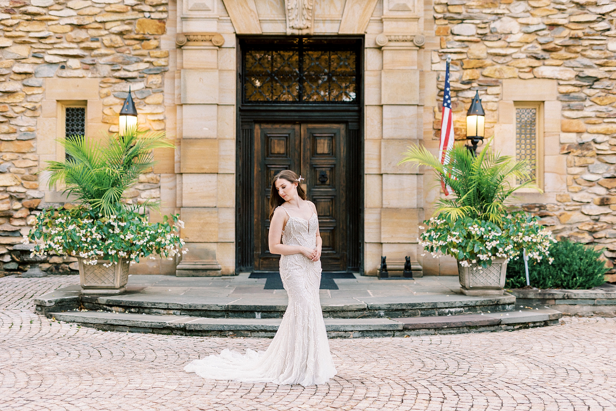 bride smiles in front of the Graylyn Estate