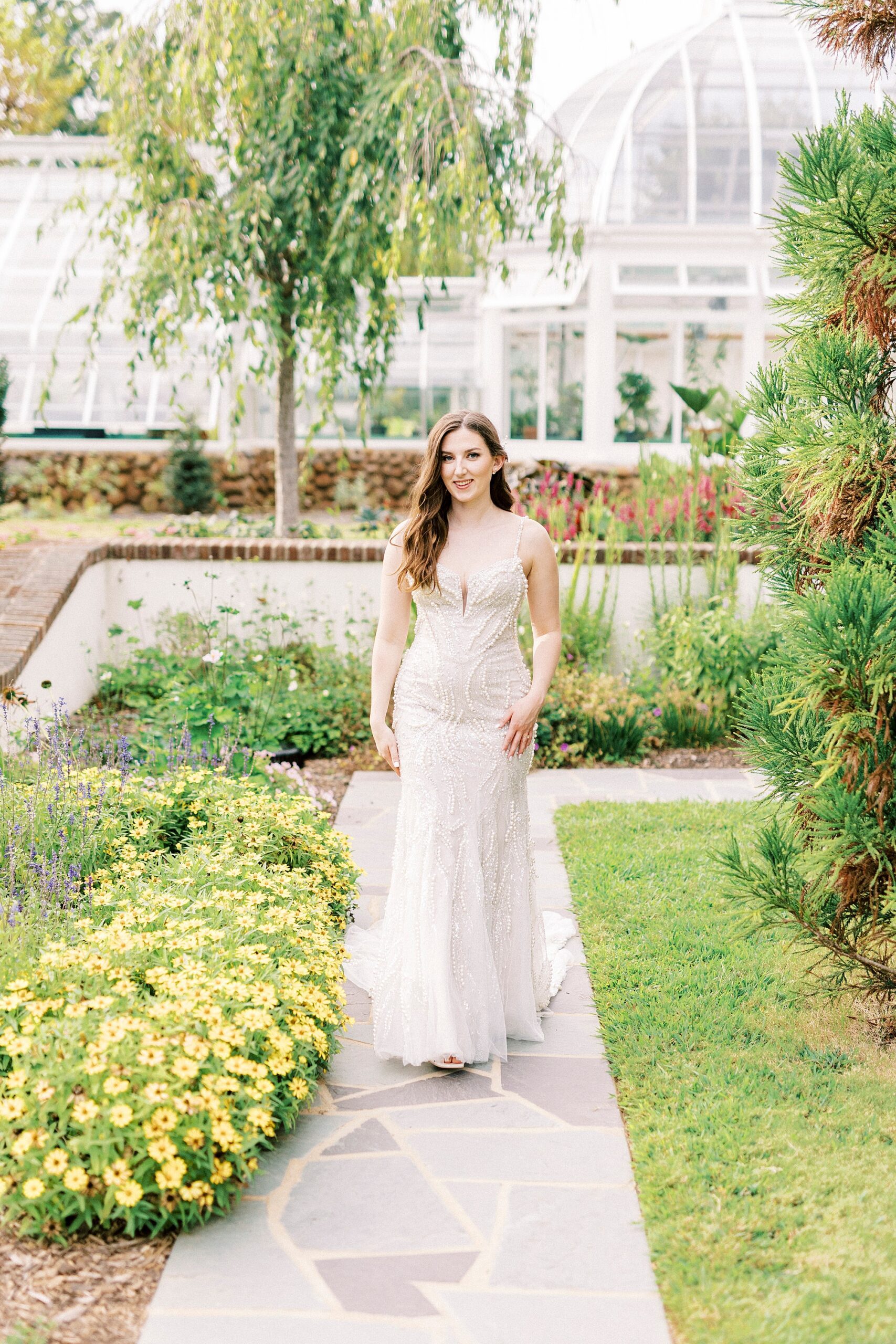 bride walks through the gardens at the Graylyn Estate