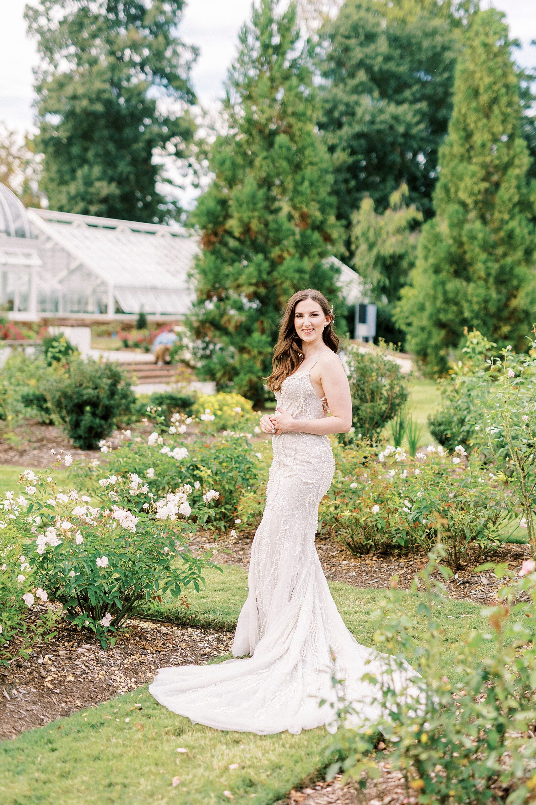 bride to be smiles standing in Reynolda Gardens