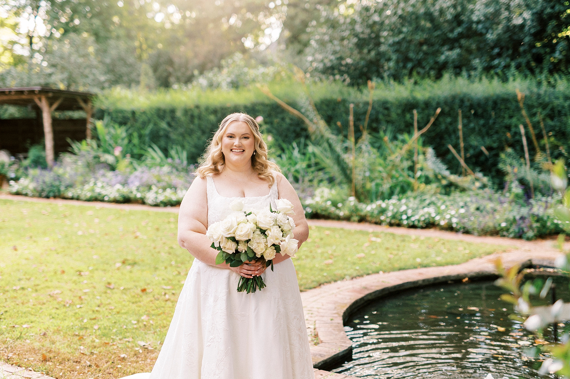 bride walks by pond inside Wing Haven Gardens