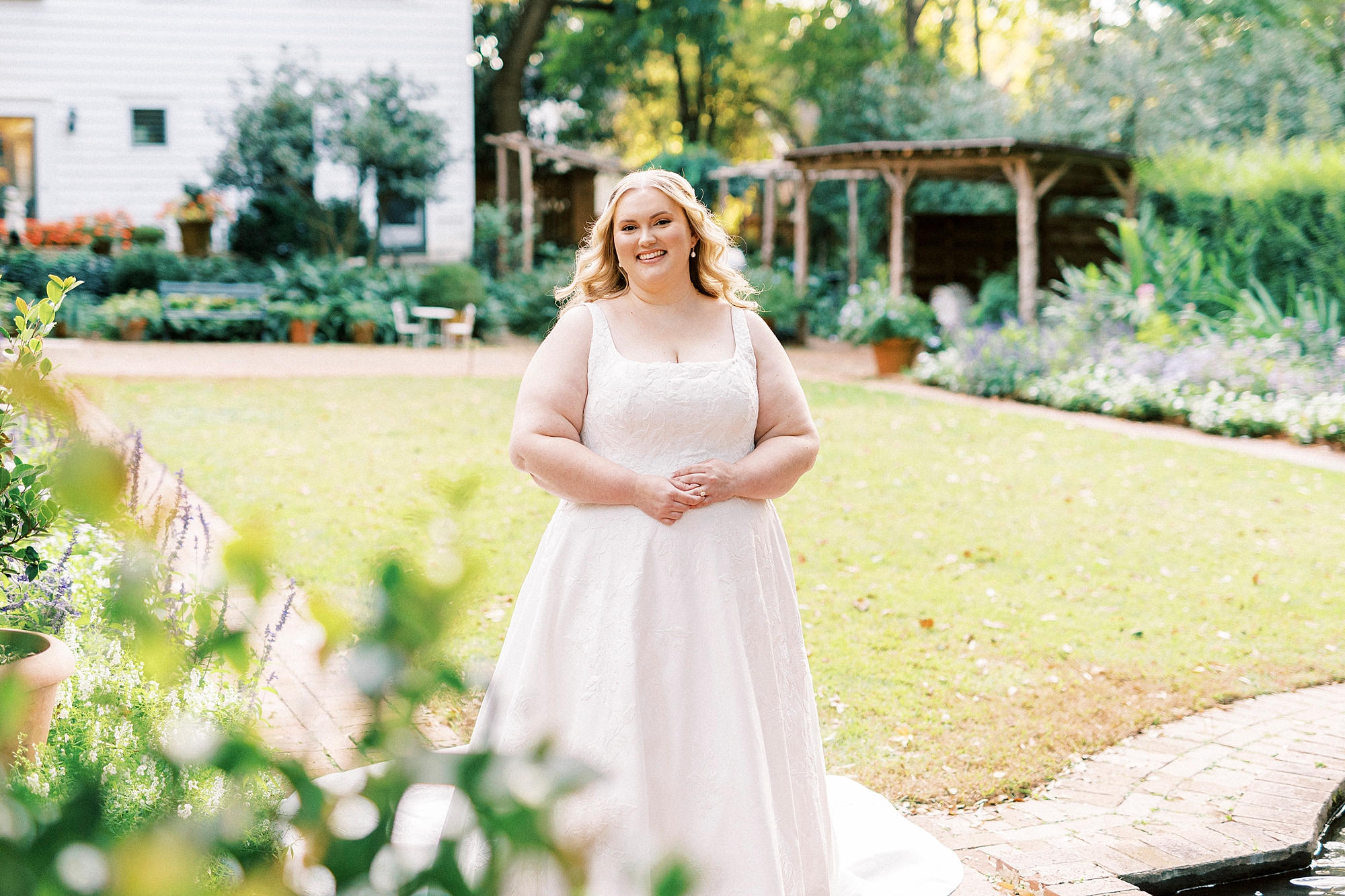 bride smiles during portraits inside Wing Haven Gardens