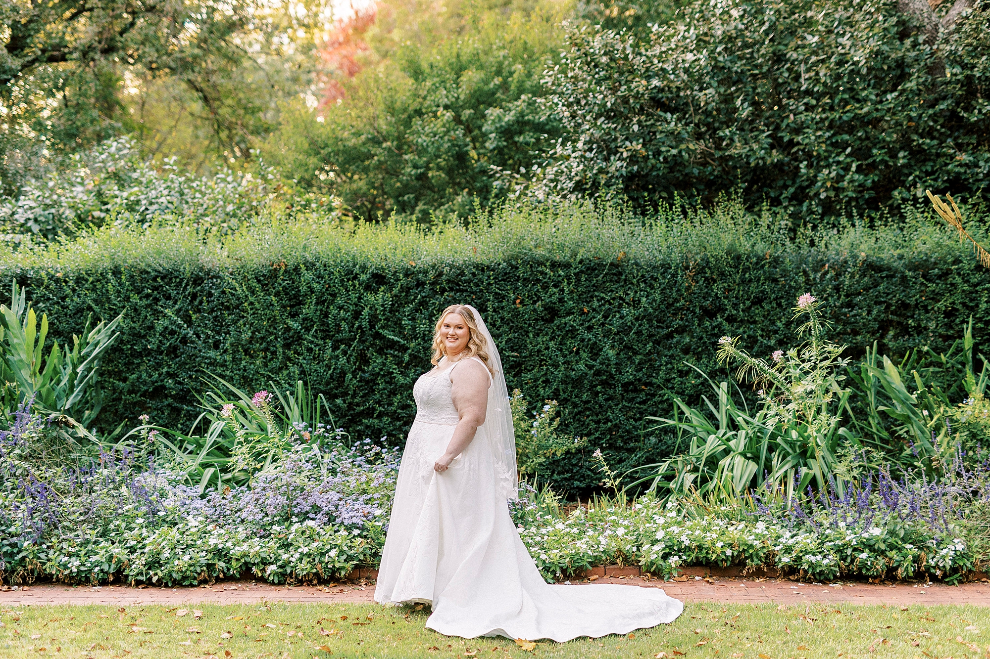 bride walks through Wing Haven Gardens in Charlotte NC