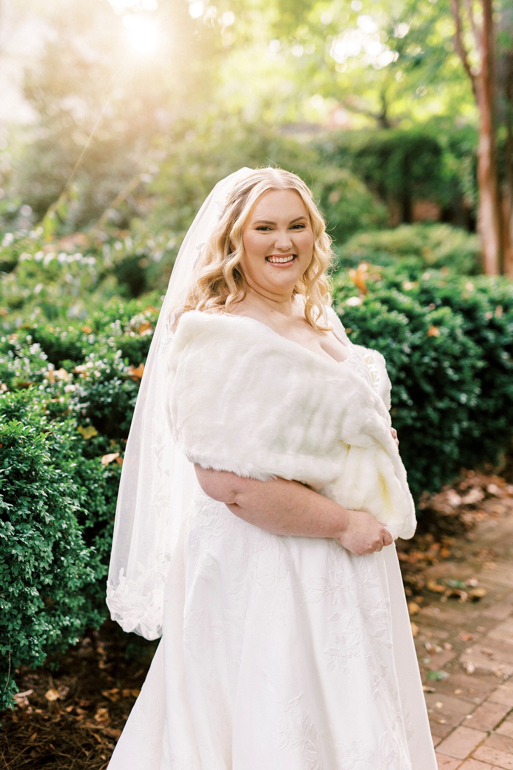 blonde bride poses in fur wrap during portrait session 