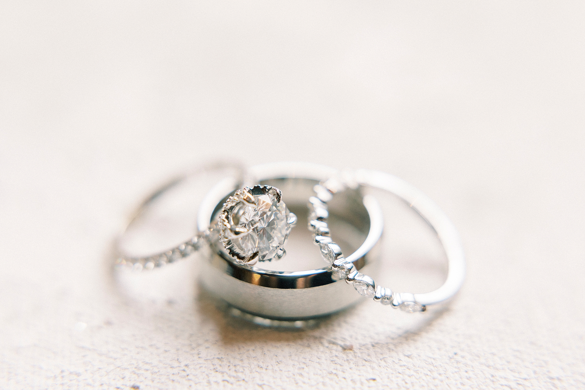 three wedding rings stacked together on ivory background