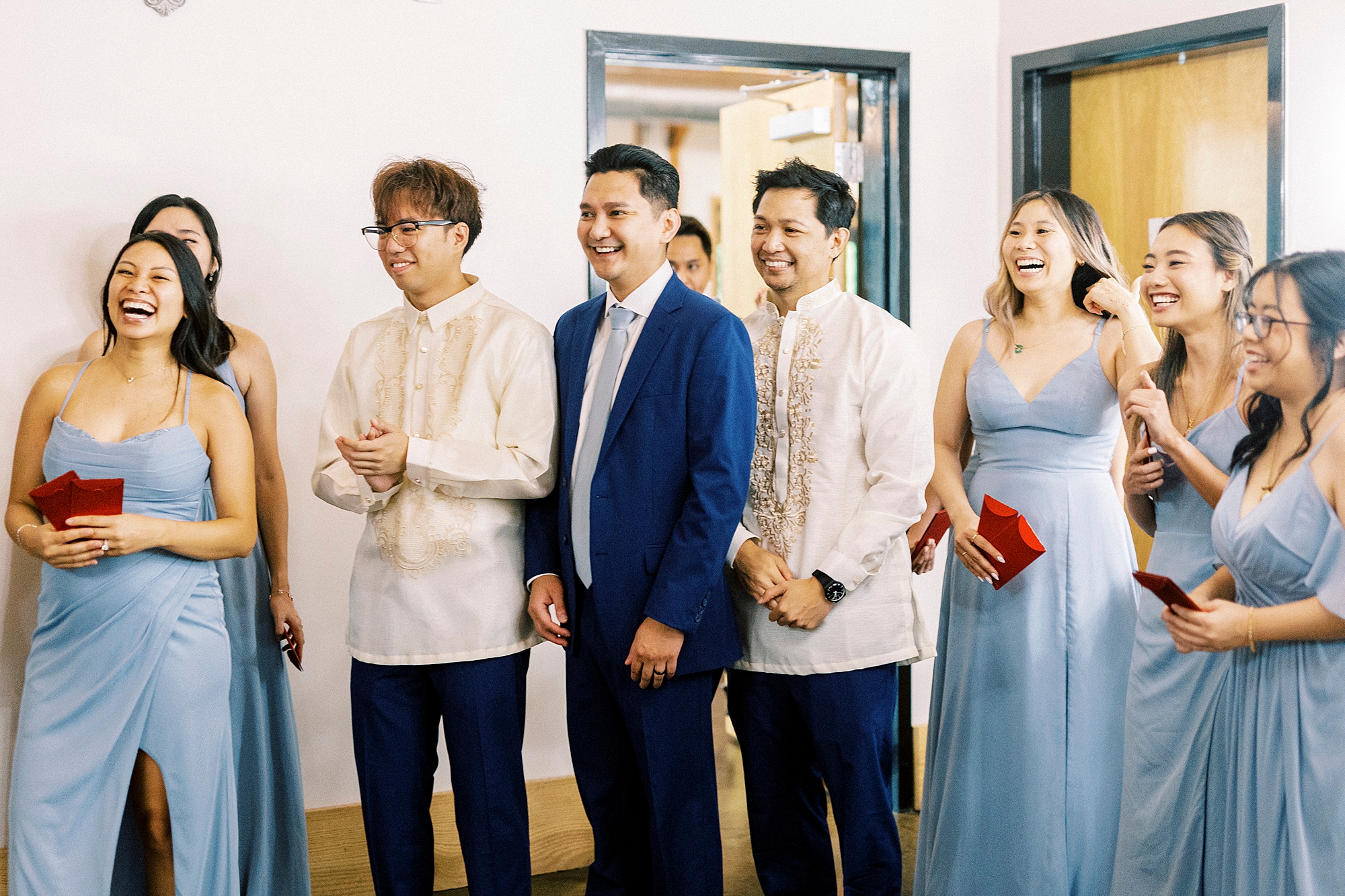 bridal party helps groom reach bride during tea ceremony 