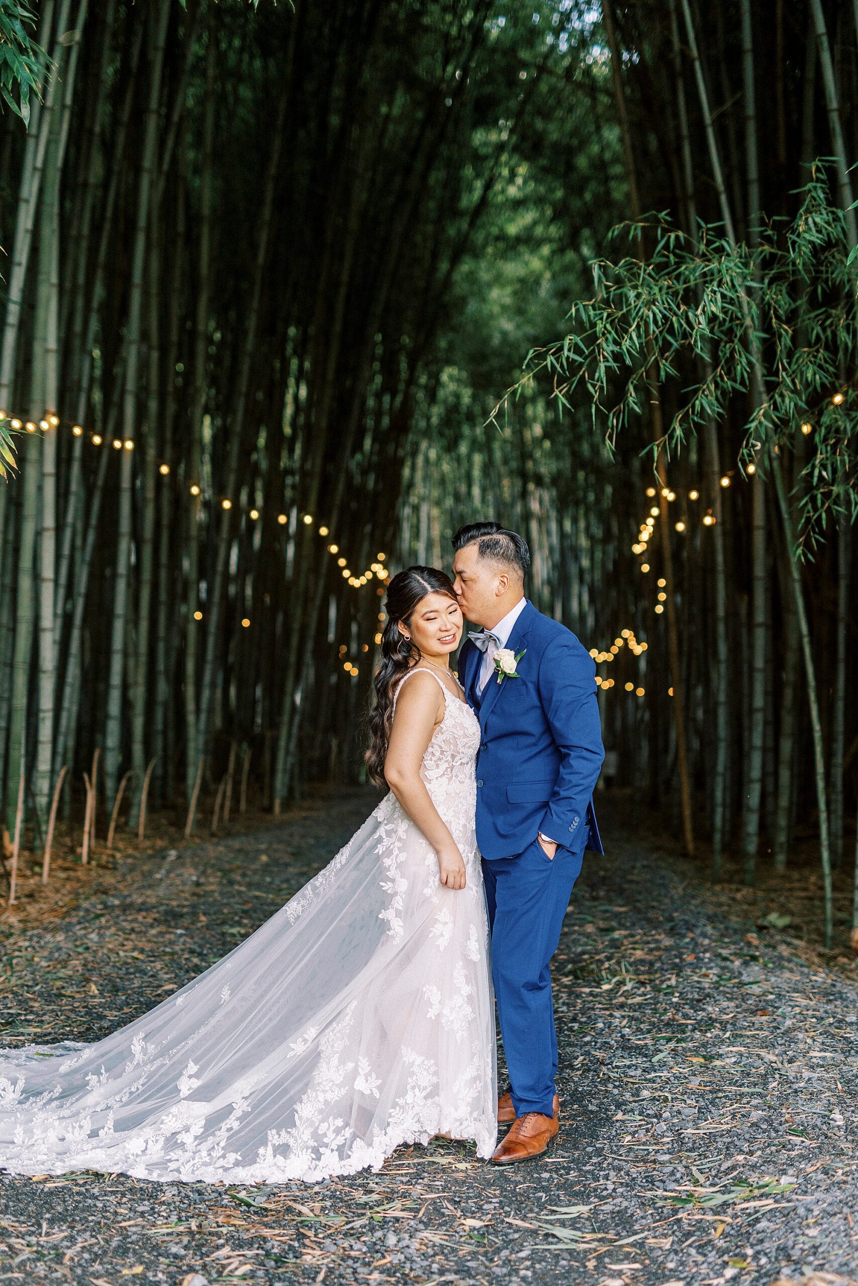 groom hugs bride's forehead inside v