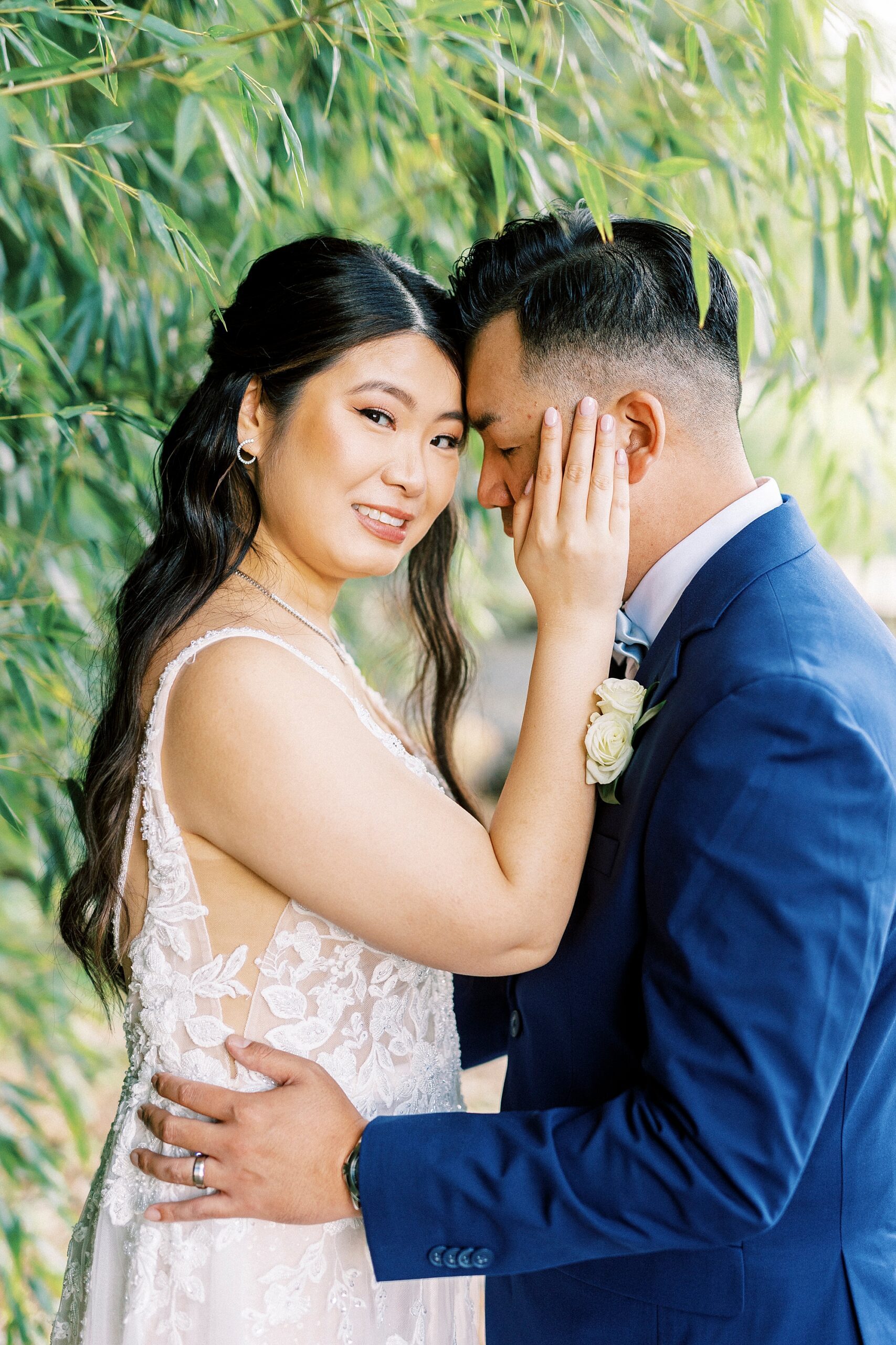 bride and groom lean together hugging on wedding day