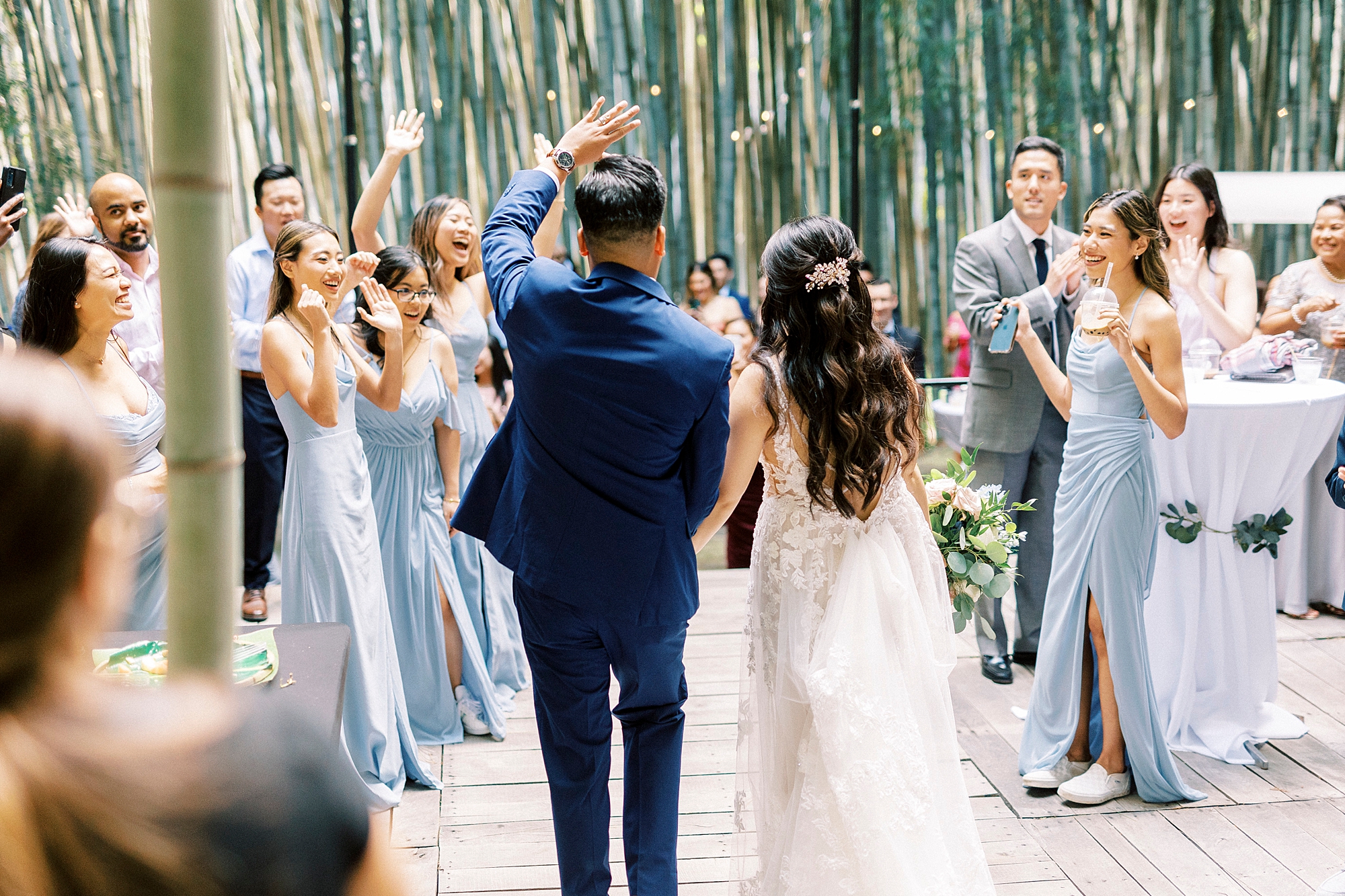 bride and groom walk through bamboo forest at Camelot Meadows