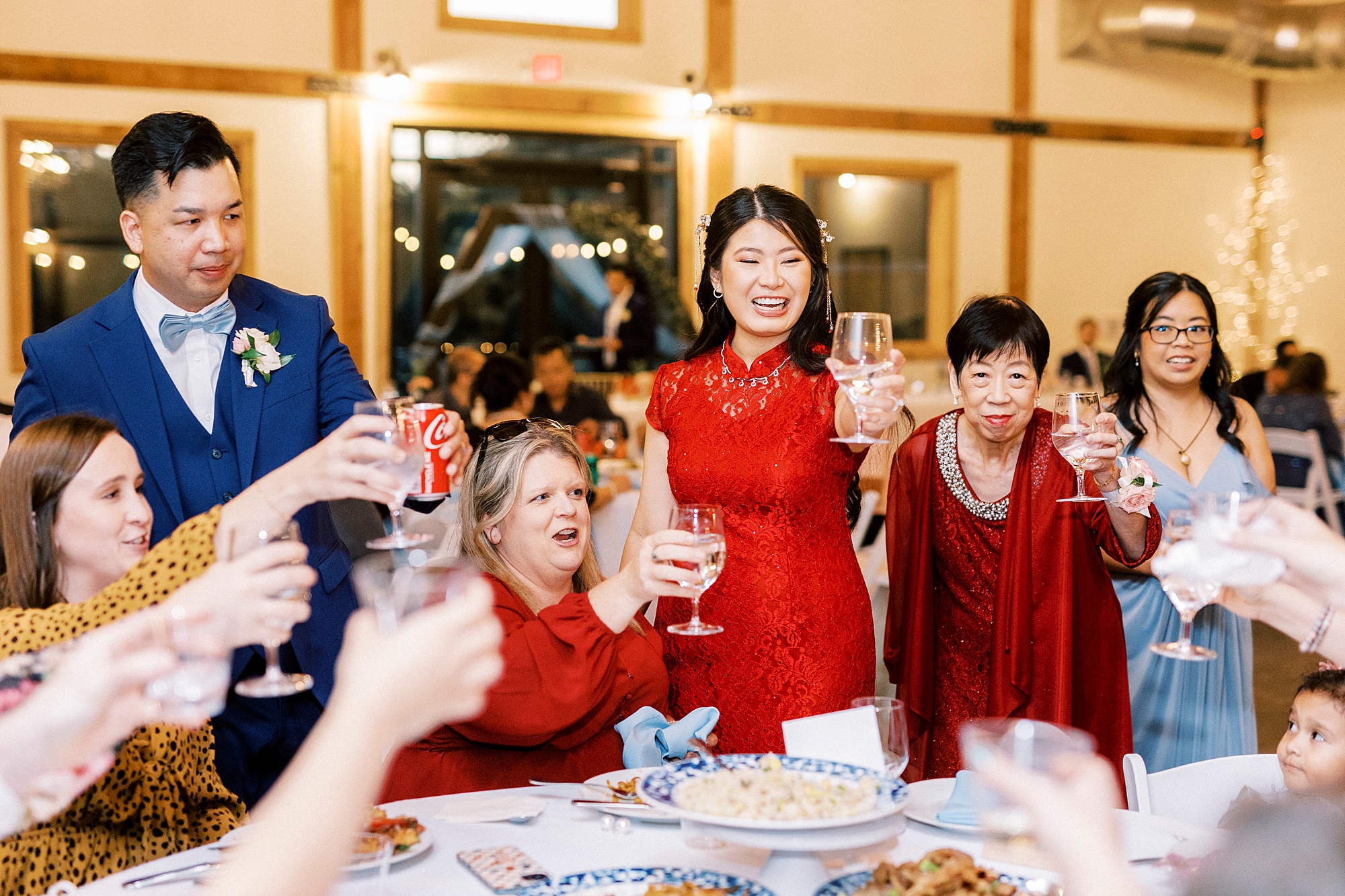 bride hugs guests standing in traditional Chinese attire