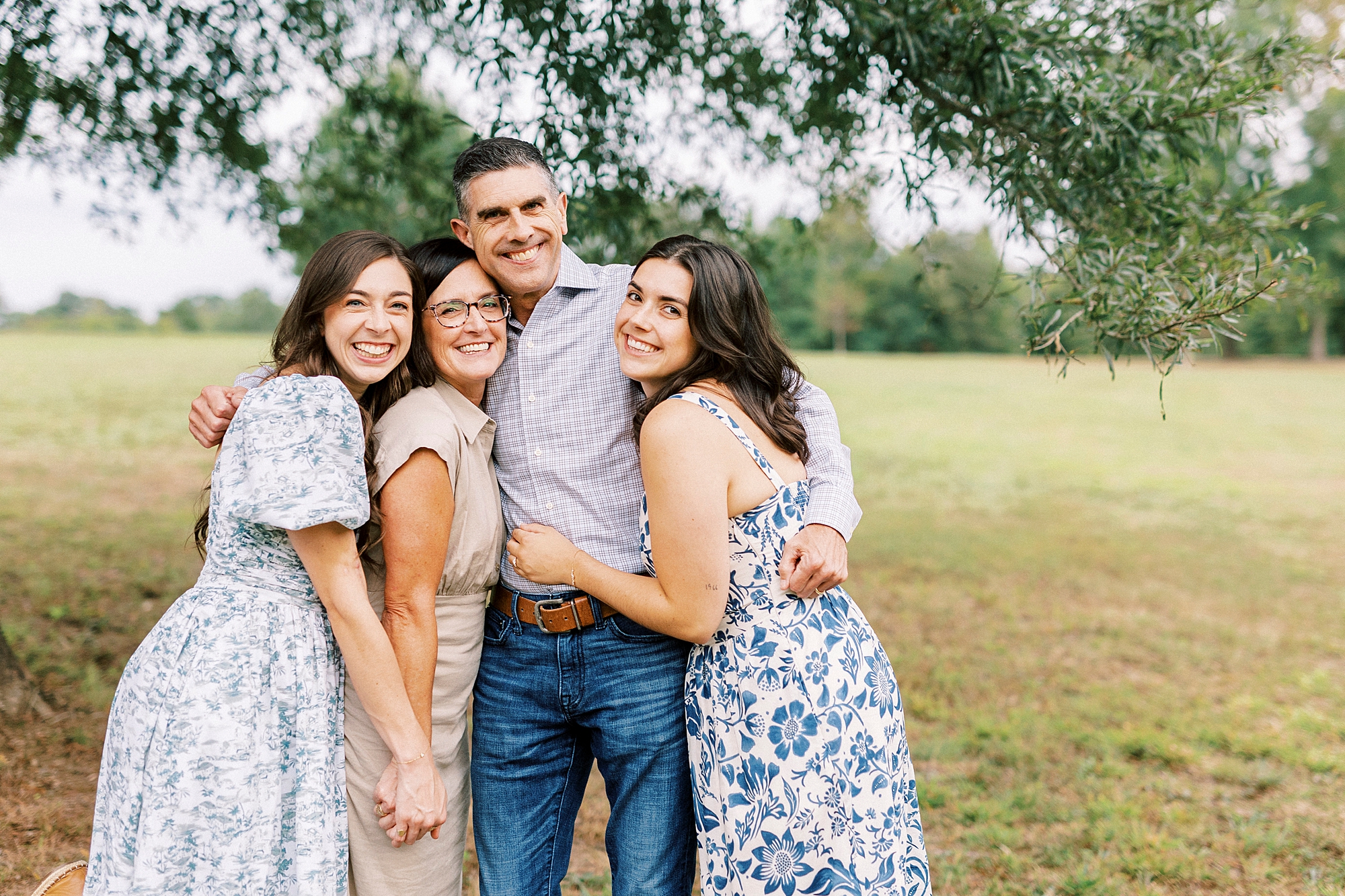 adult daughter hug parents during family photos in Rob Wallace Park