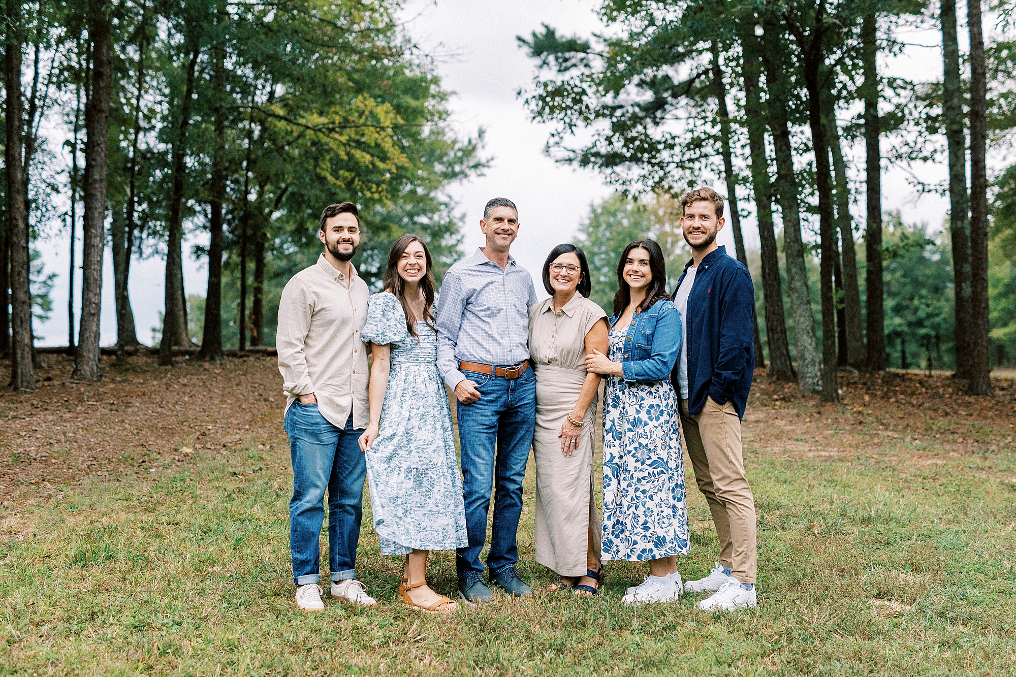 couple hug adult wives and son in laws during family photos at Rob Wallace Park