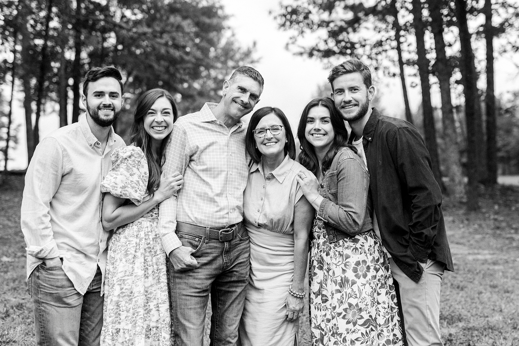 parents hug with adult daughters and sons in law during family photos at Rob Wallace Park