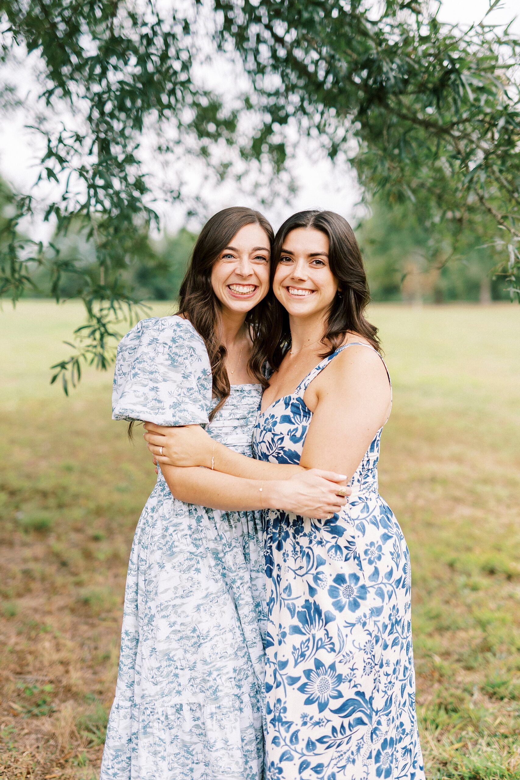 sisters hug during family photos at Rob Wallace Park
