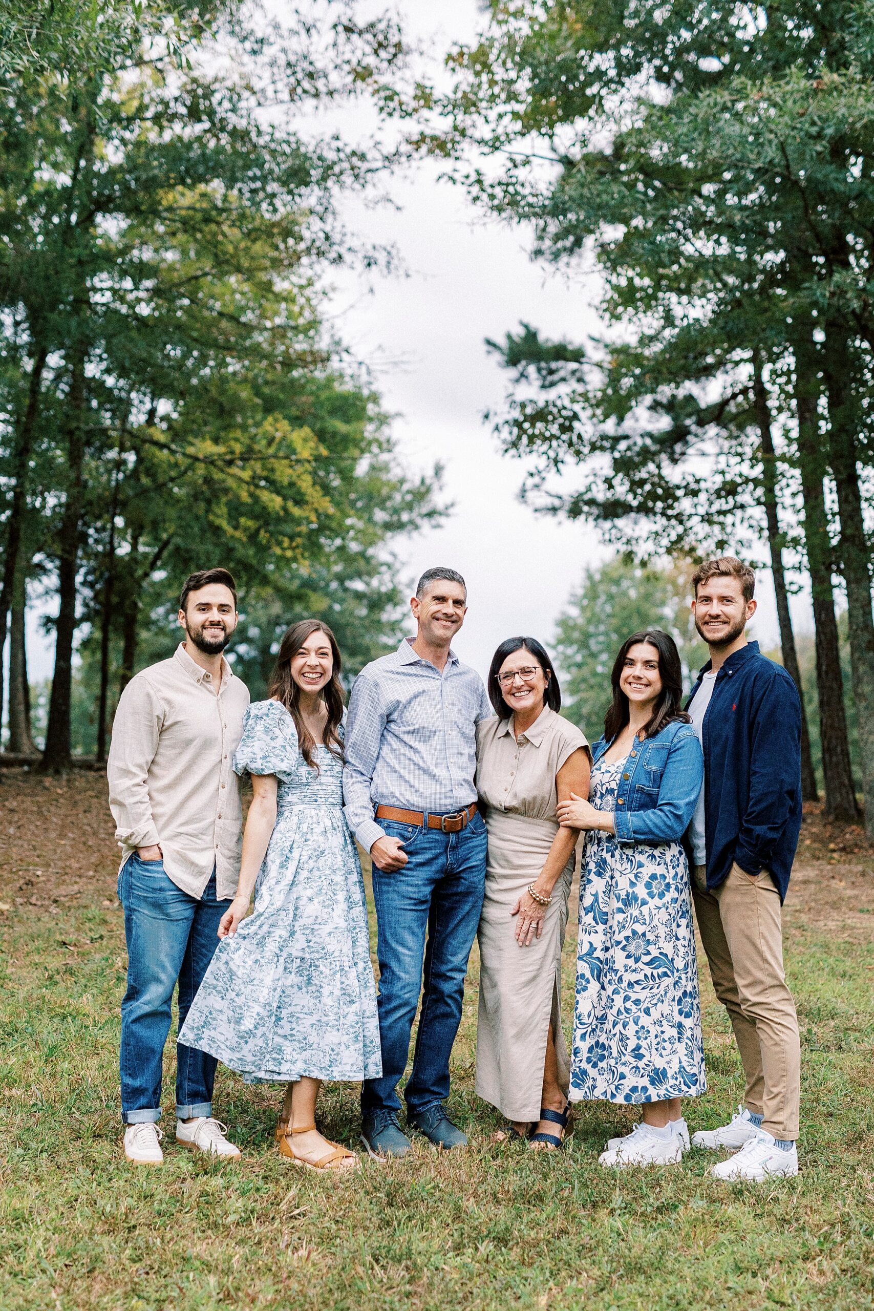 family hugs between pine trees at Rob Wallace Park