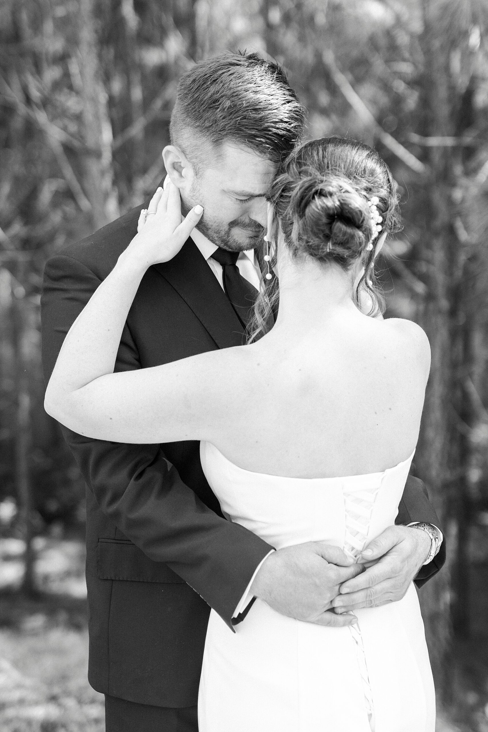 bride hugs groom holding her arms around his neck