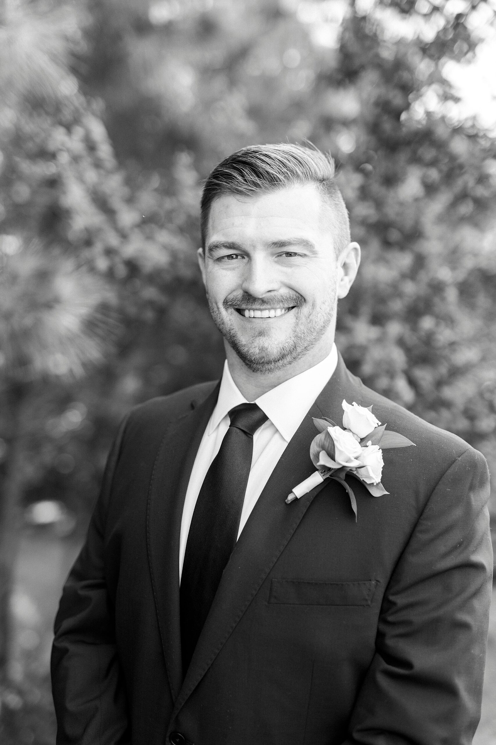 groom smiles standing in suit for NC wedding day
