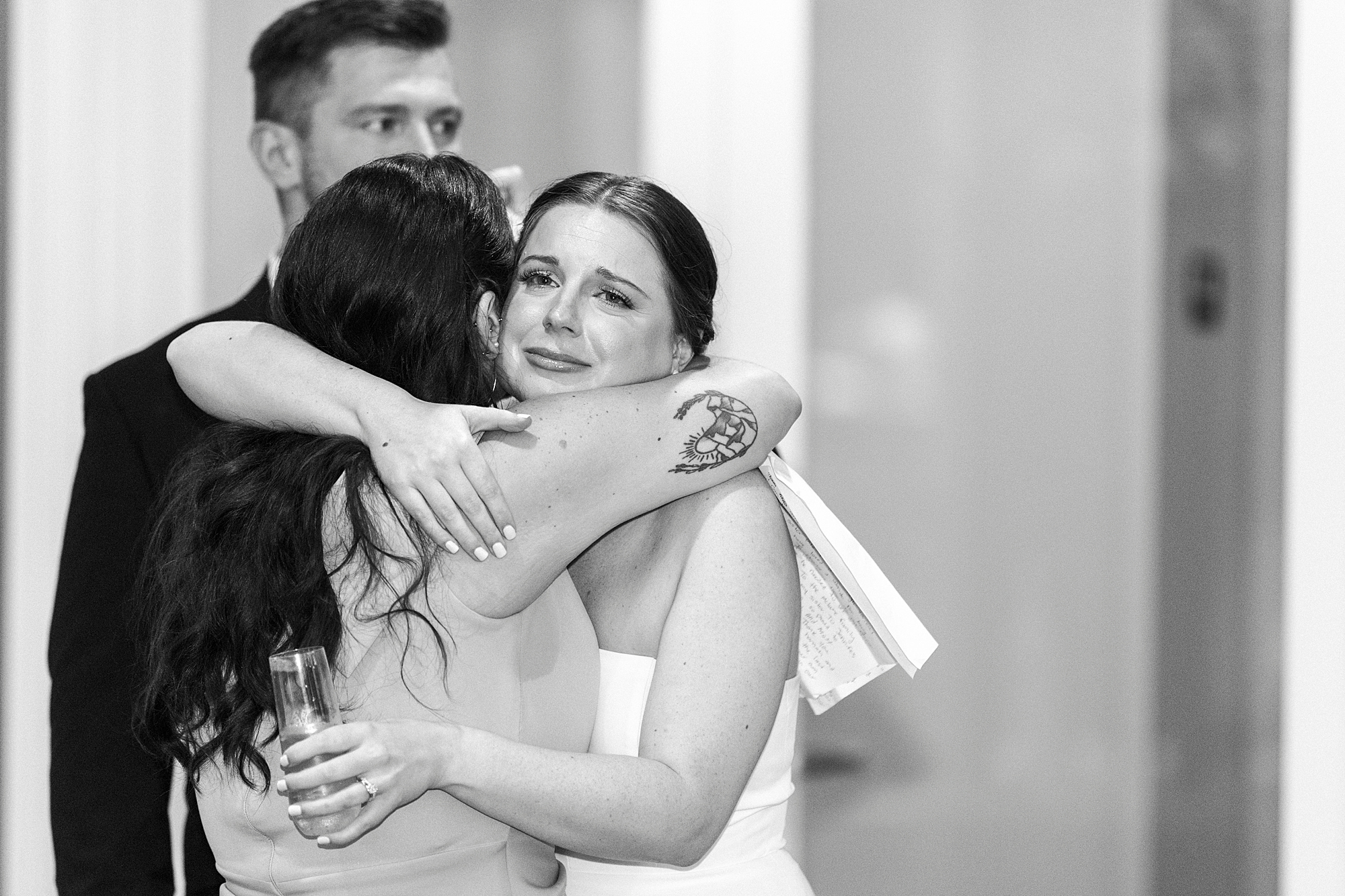 bride hugs bridesmaid after toast 
