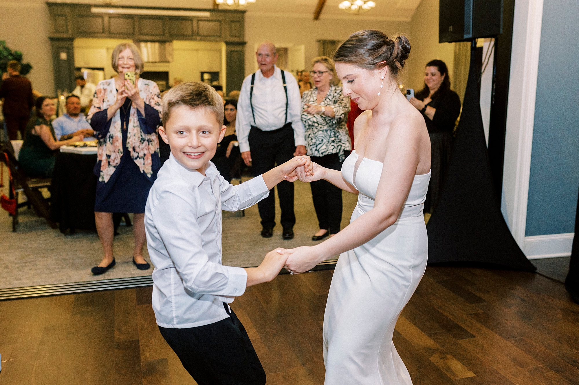 wedding guests dance during wedding reception at Palisades Country Club