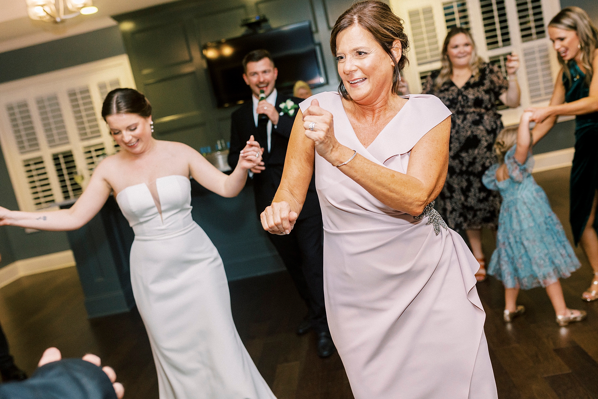 wedding guests dance during wedding reception at Palisades Country Club