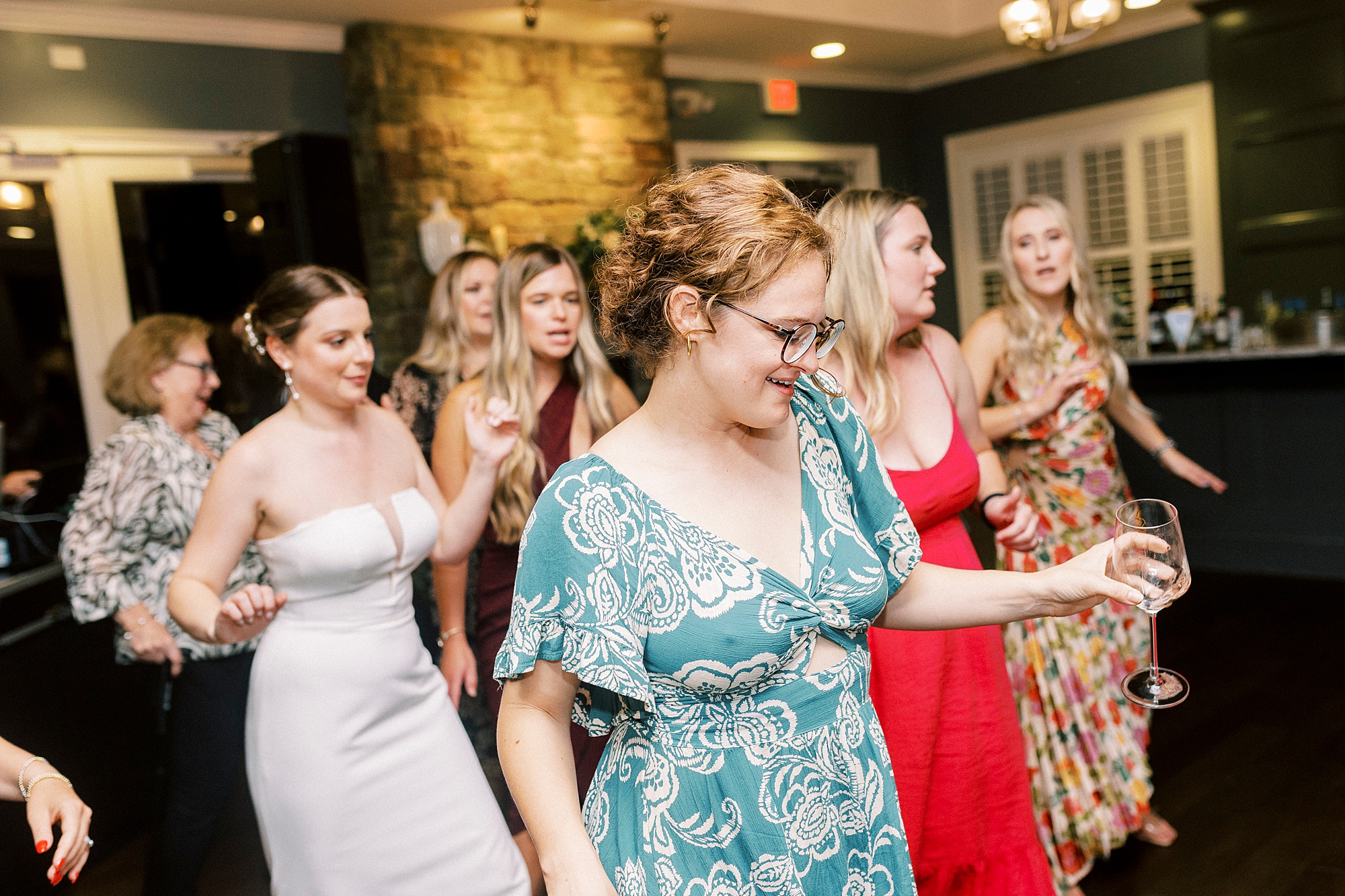 wedding guests dance during wedding reception at Palisades Country Club