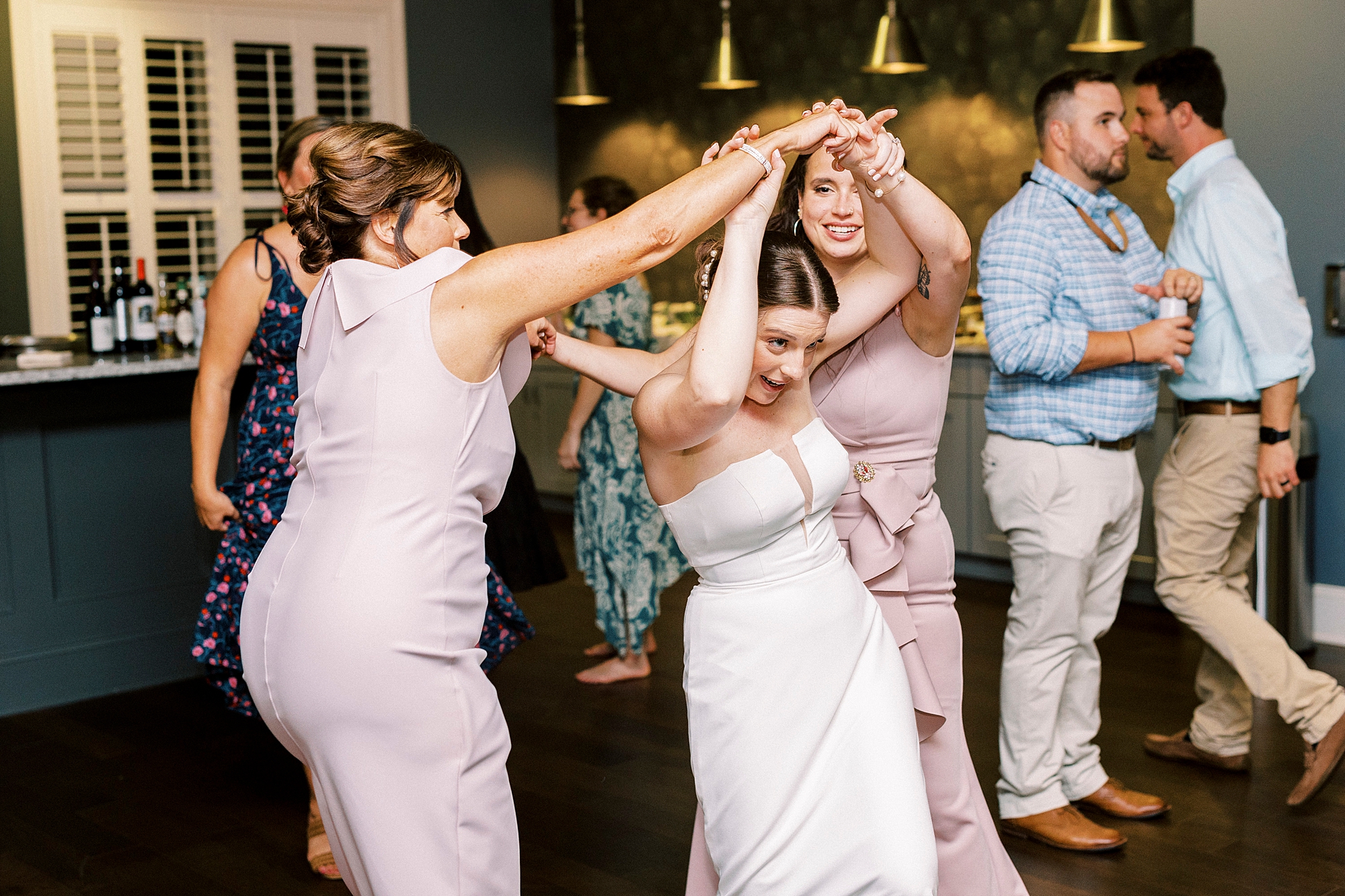 wedding guests dance during wedding reception at Palisades Country Club