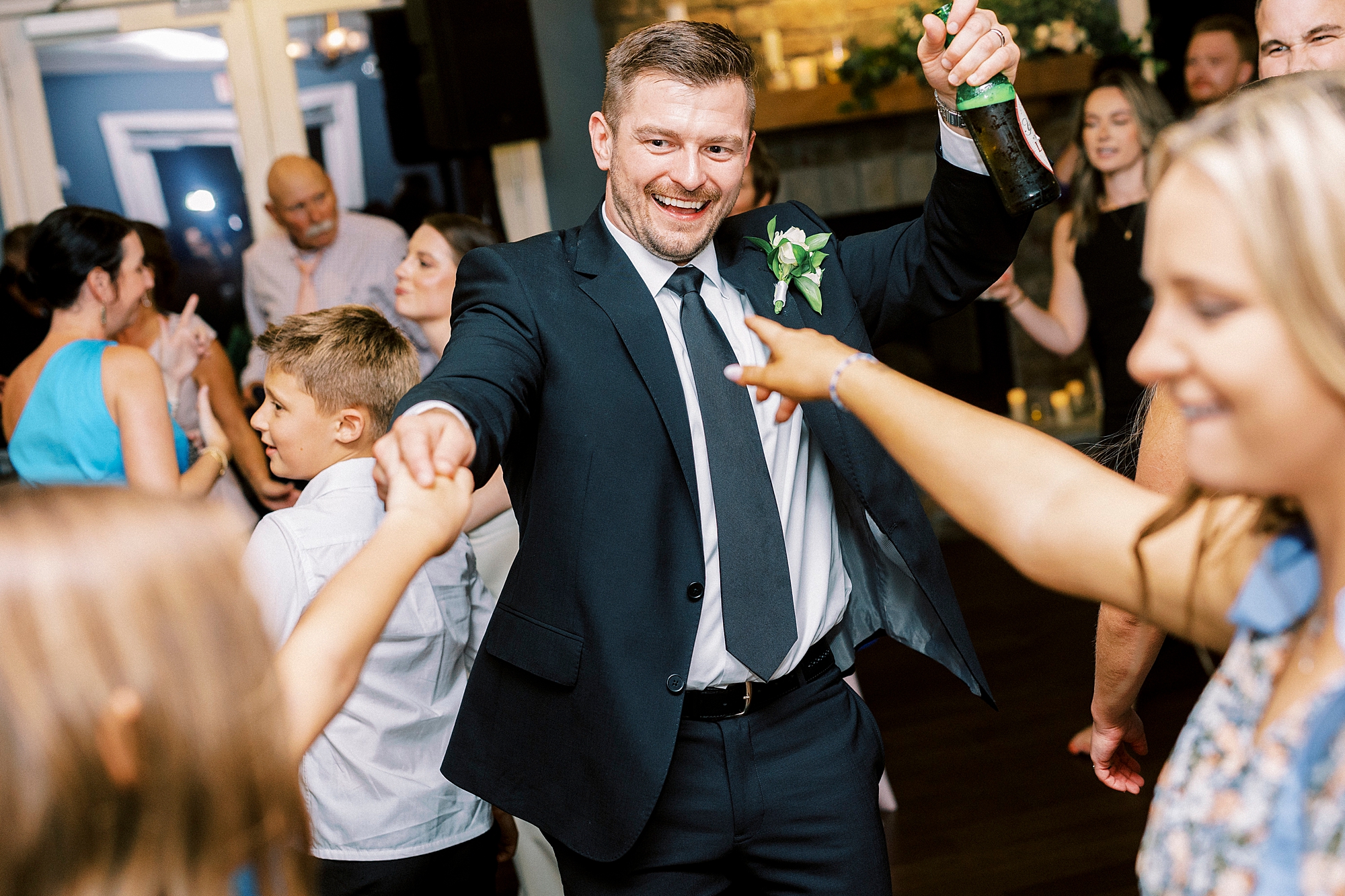 wedding guests dance during wedding reception at Palisades Country Club