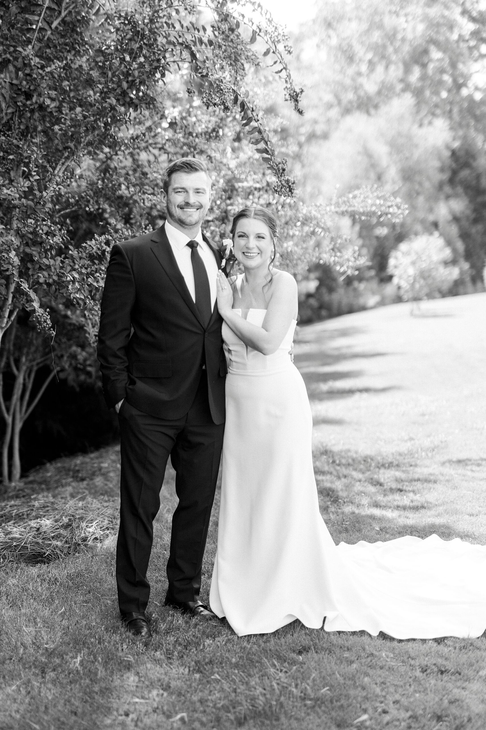 newlyweds stand together on lawn during wedding at the Palisades