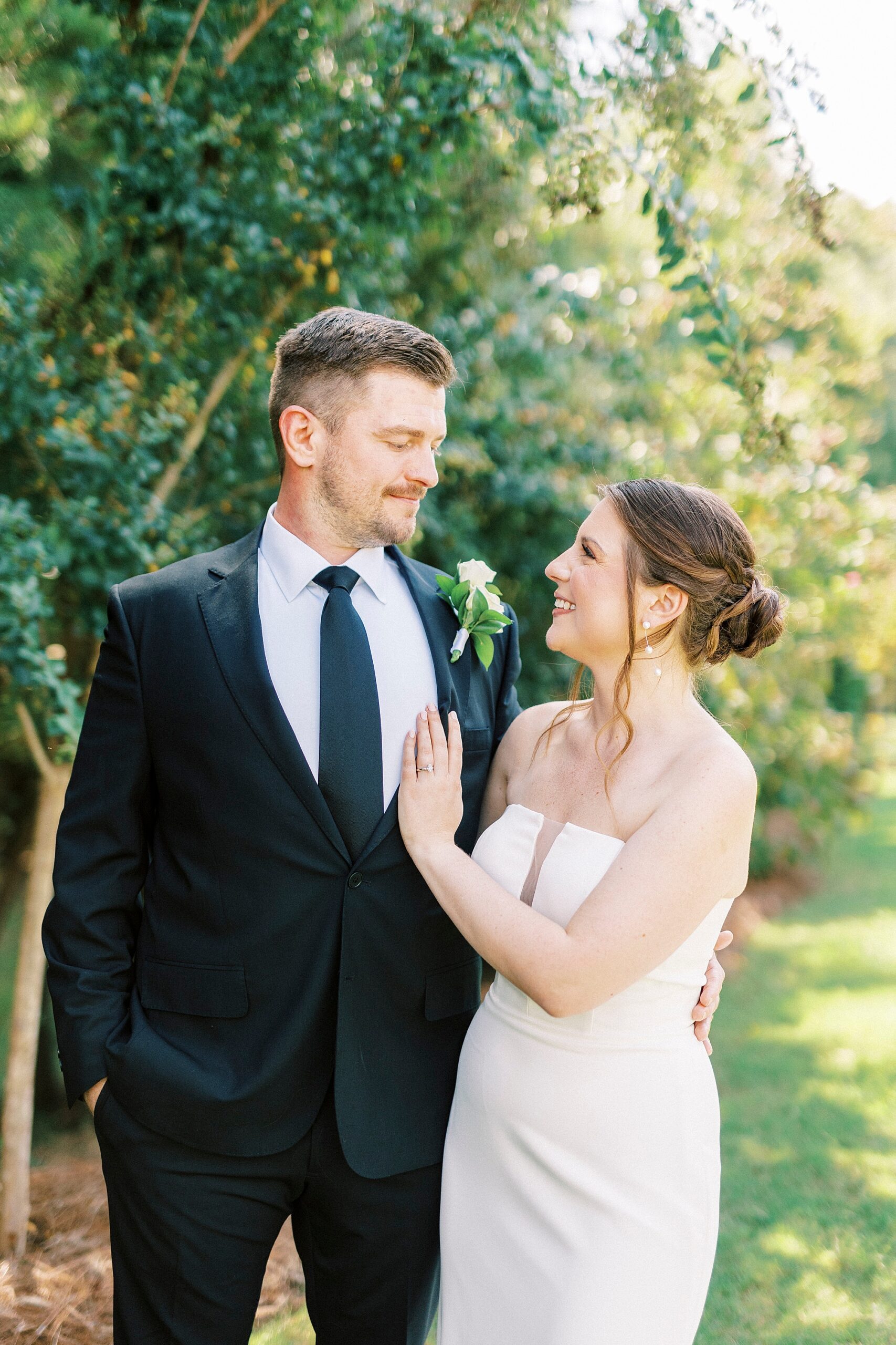 bride smiles up at groom with hand laying on his chest in North Carolina 