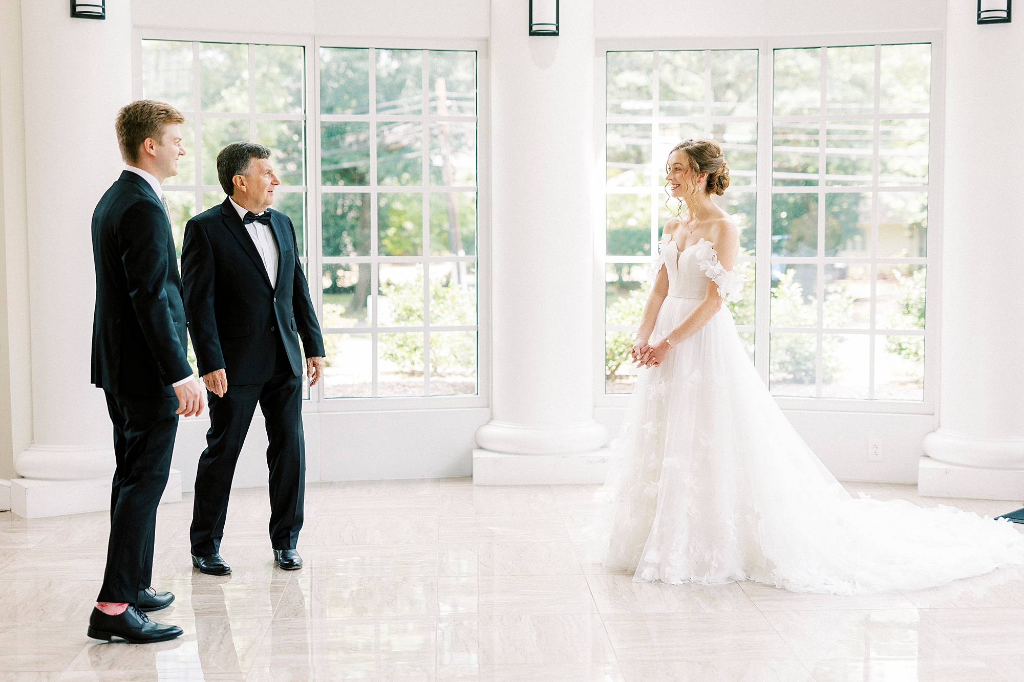 bride approaches dad and brother for first look