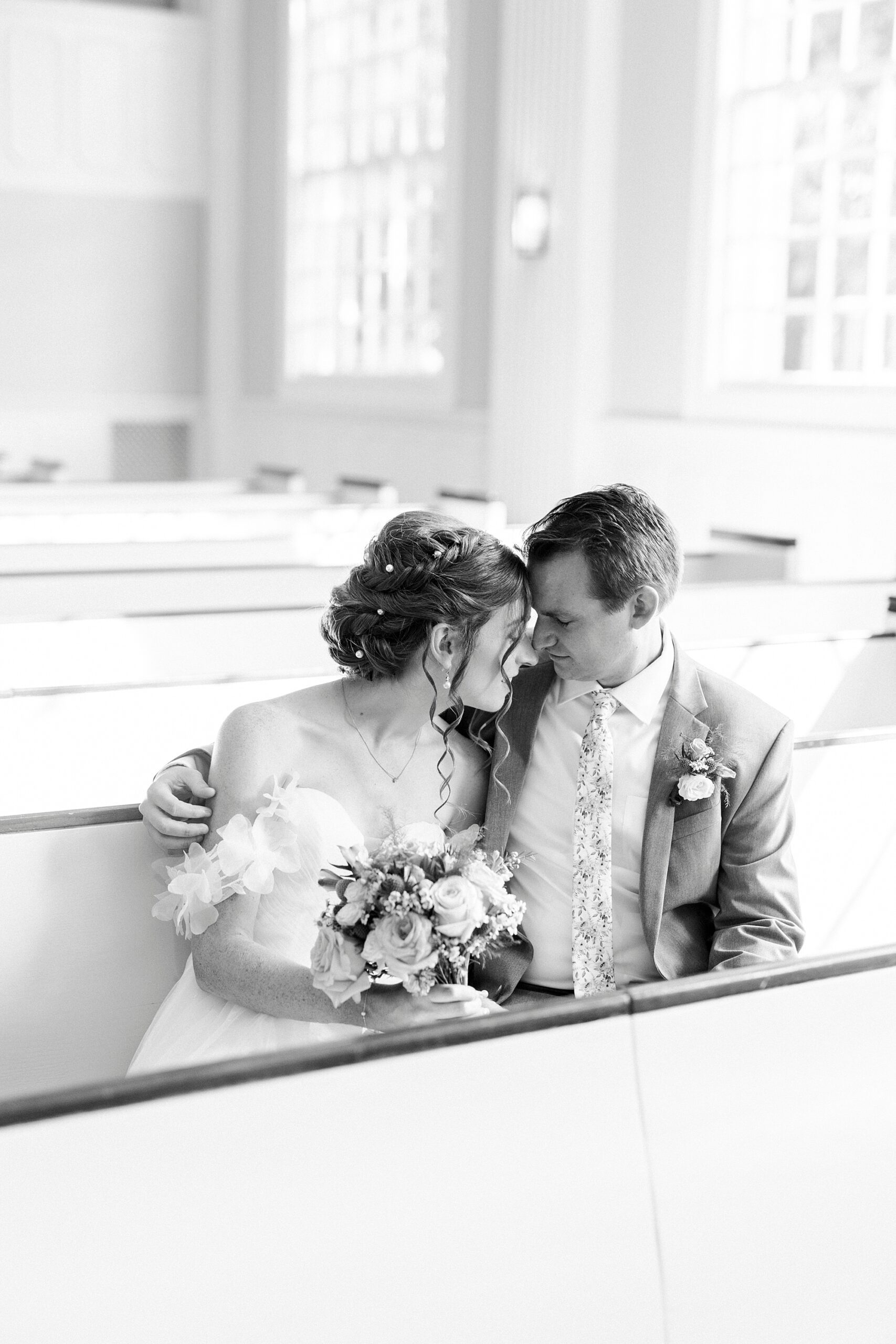 bride and groom sit inside Belk Chapel in Charlotte NC