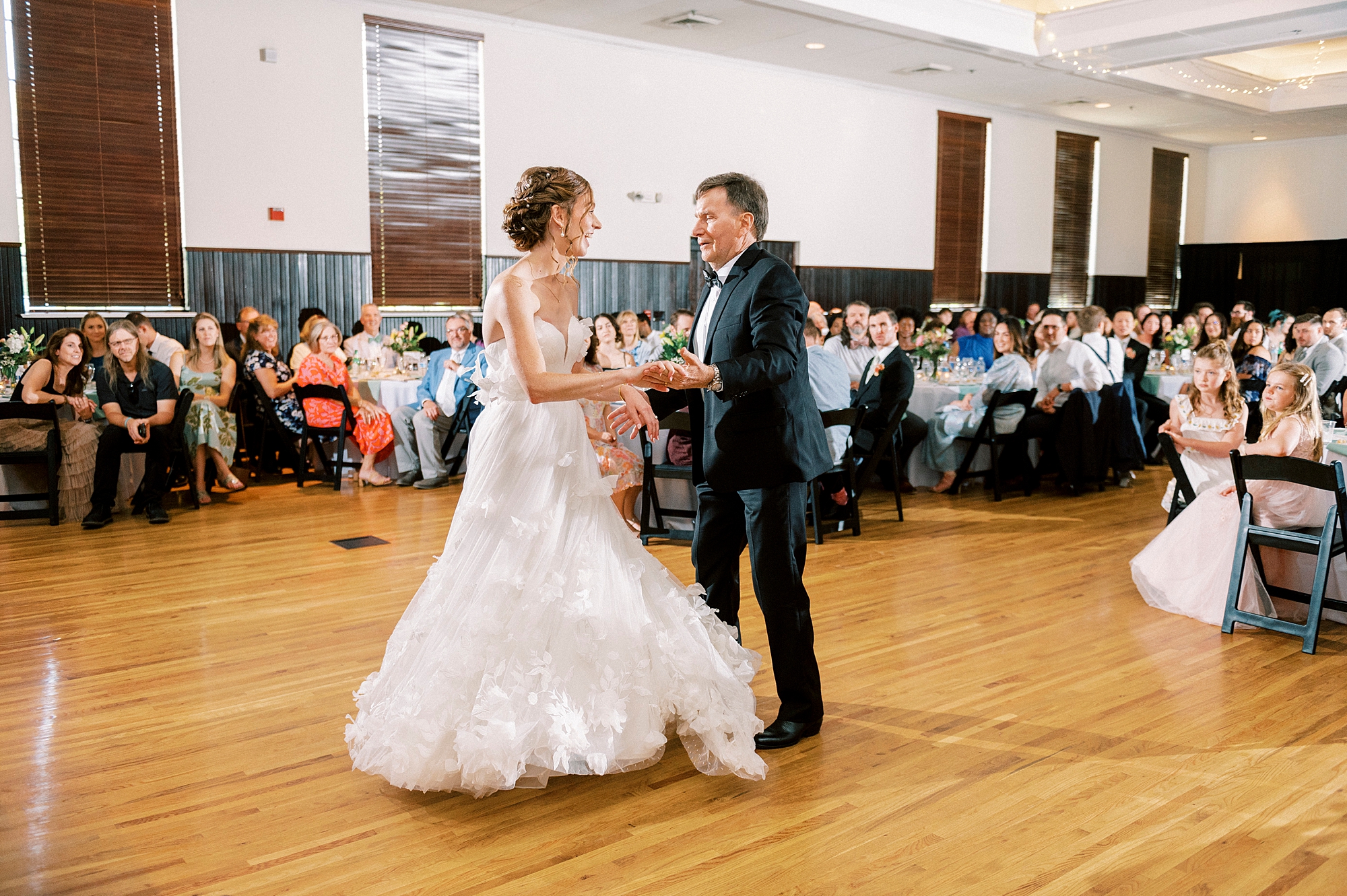 bride dances with dad during wedding reception at the Palmer Building