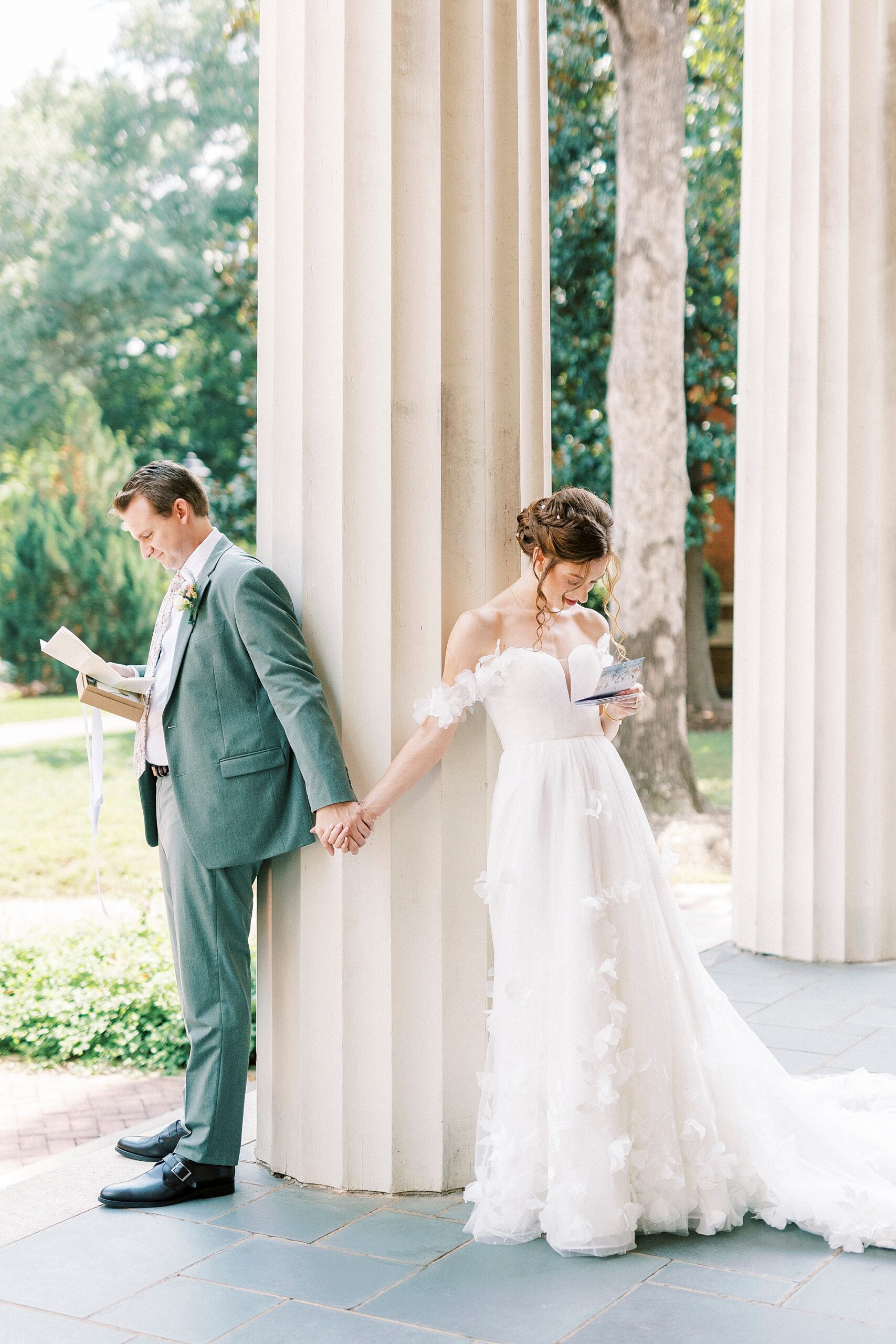 bride and groom hold hands around pillar at Belk Chapel