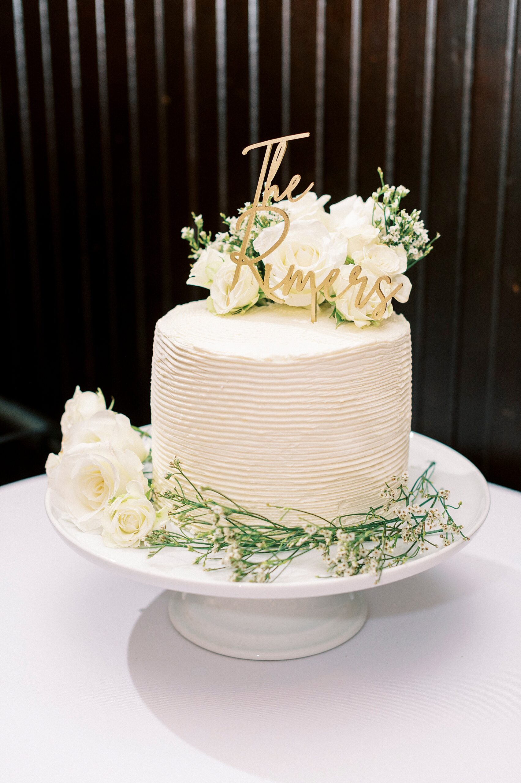 wedding cake with flowers on top during reception at the Palmer Building
