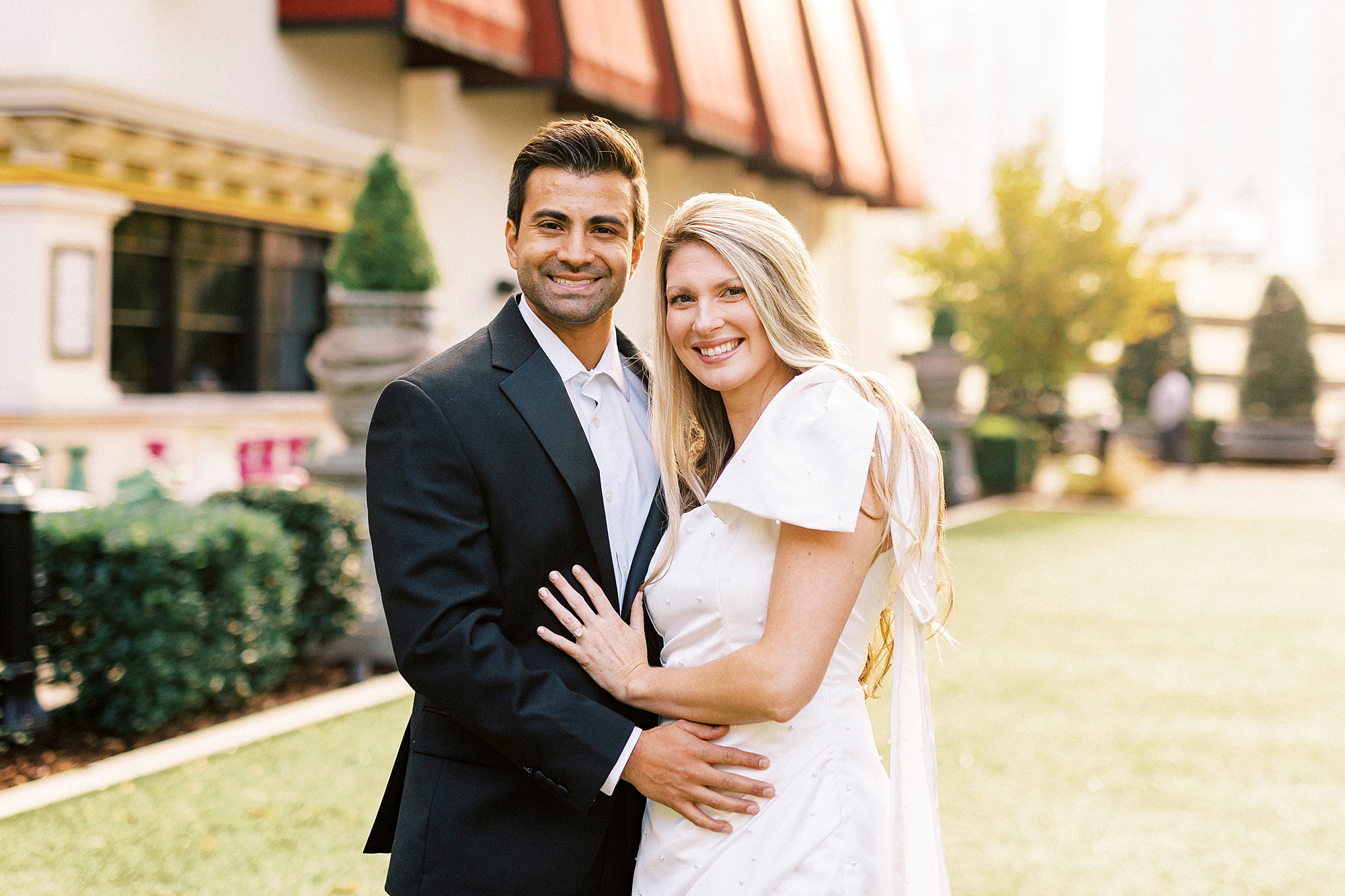 engaged couple hugs outside Charlotte hotel
