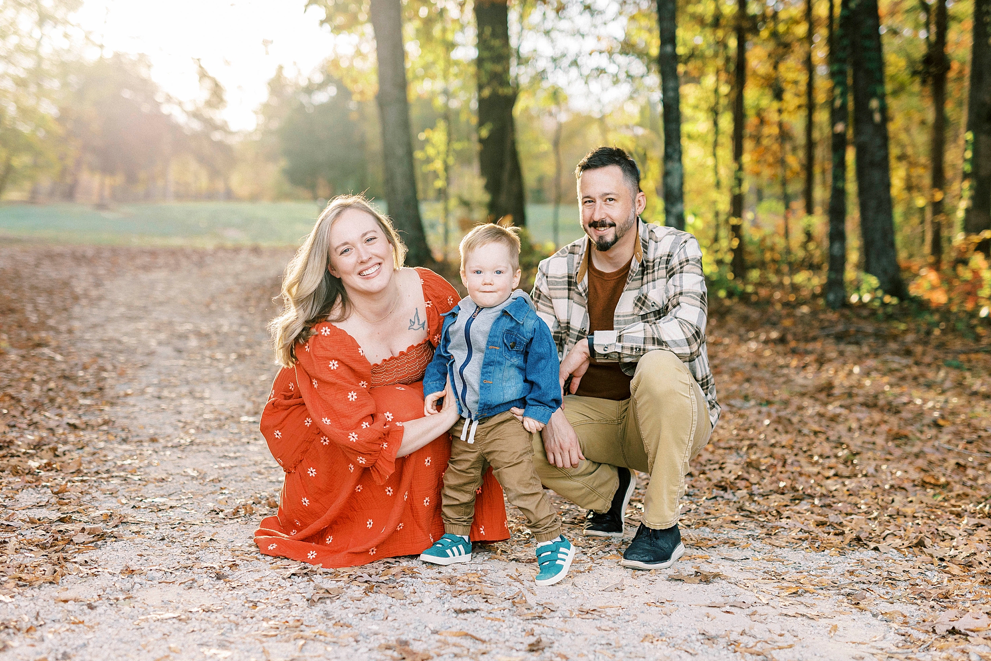 parents kneel with son at Rob Wallace Park on walkway