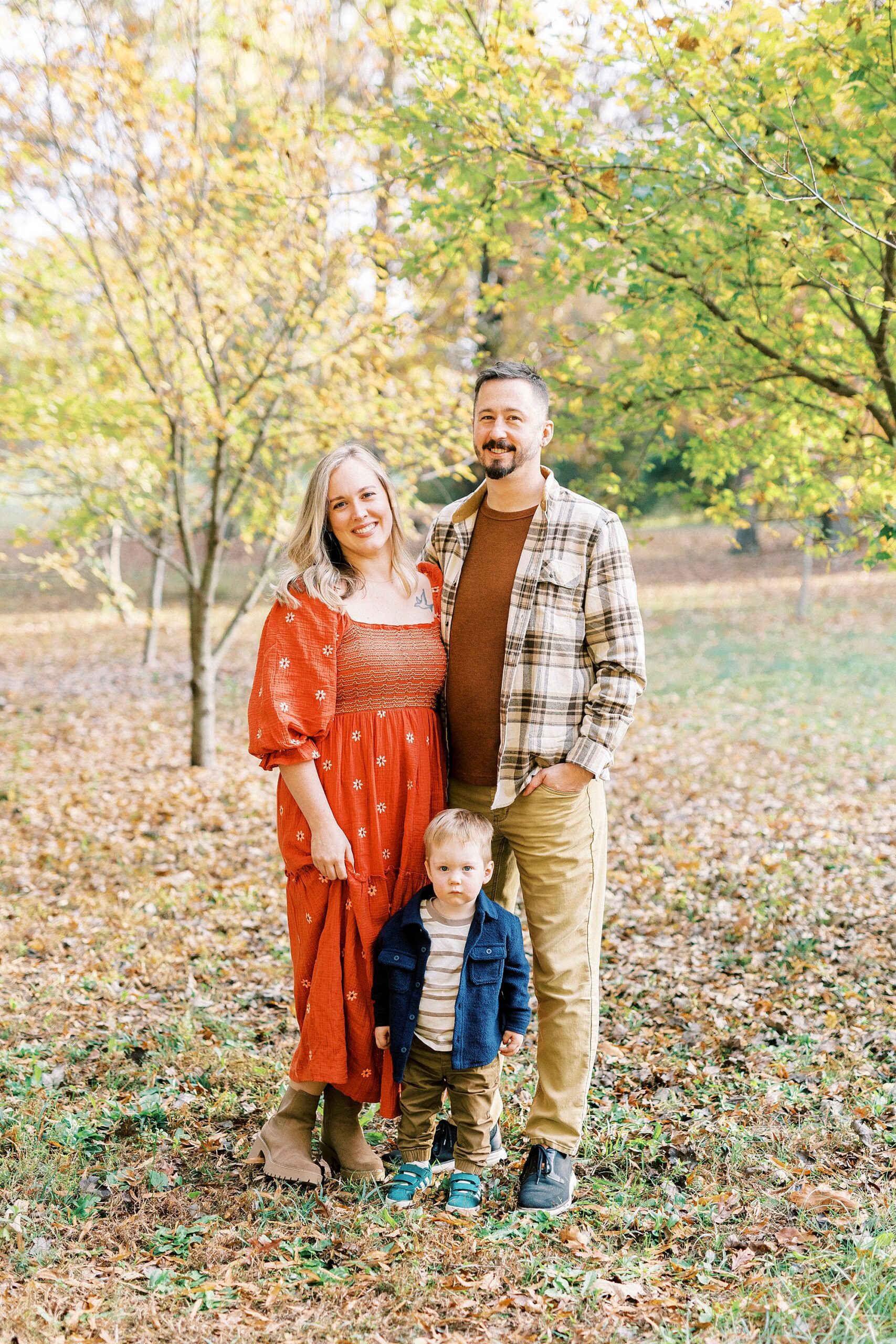 family stands together in Rob Wallace Park during fall mini sessions
