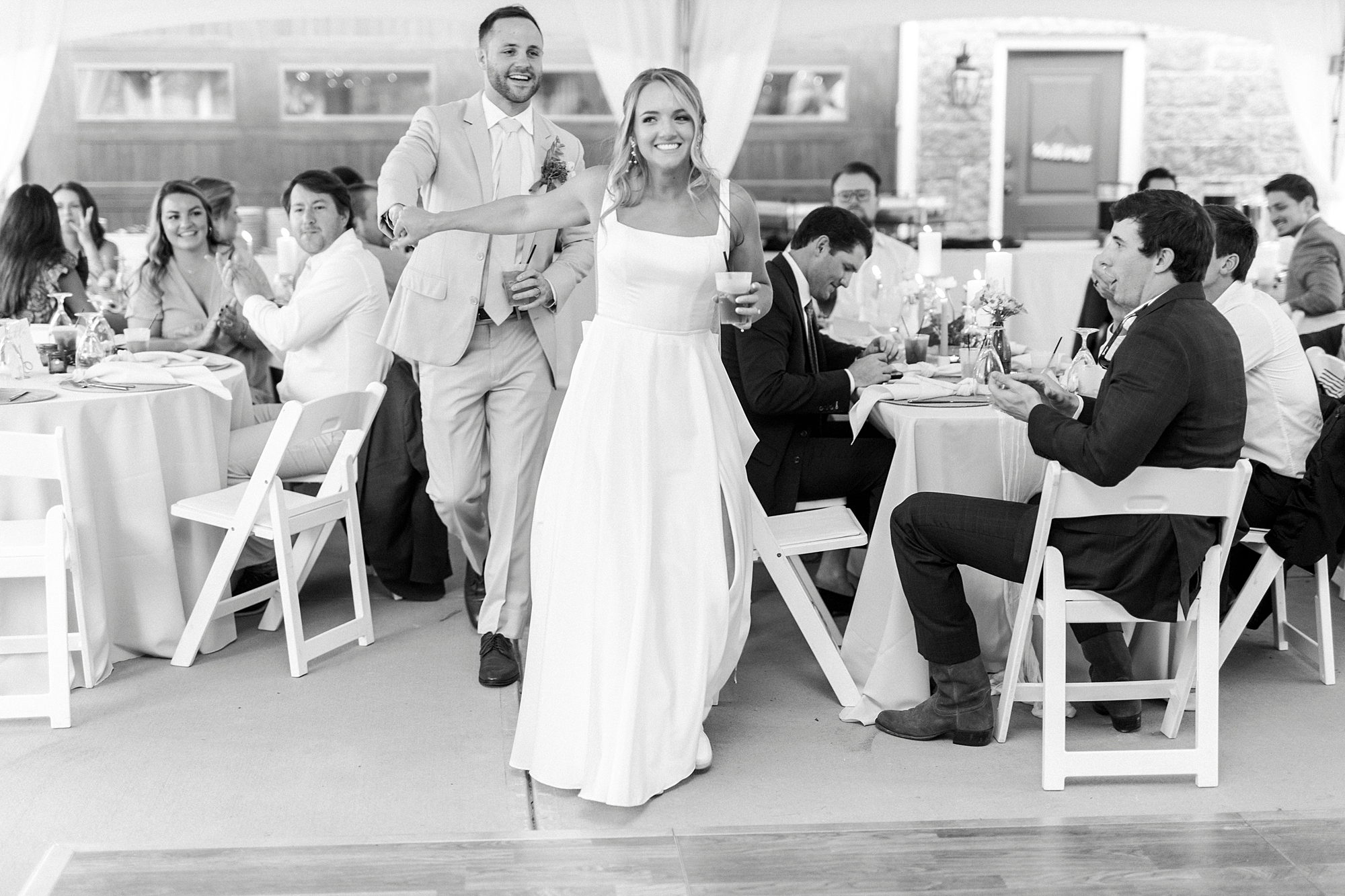 bride walks into wedding reception under tent