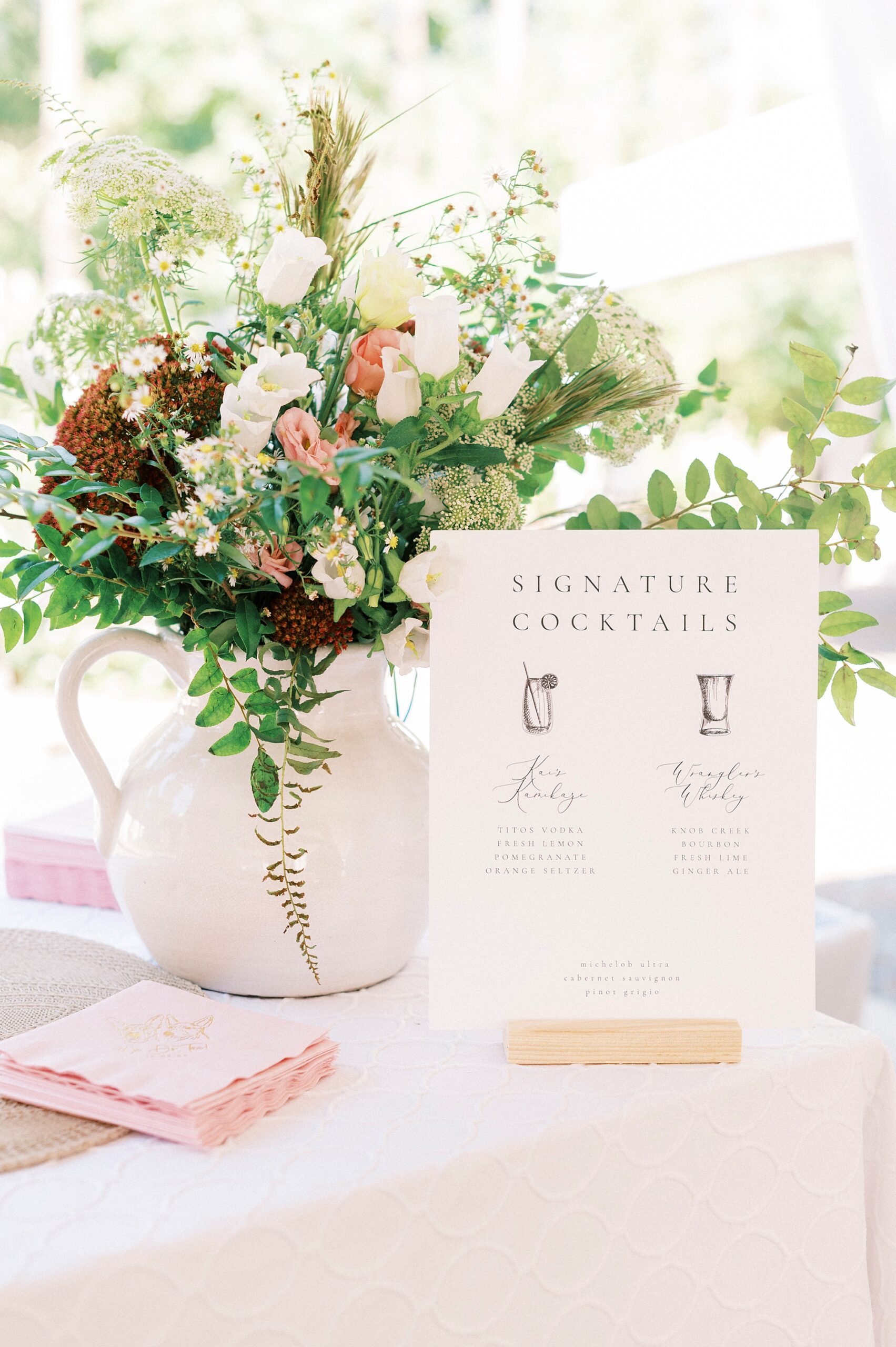 wedding reception centerpieces with white vase and custom sign