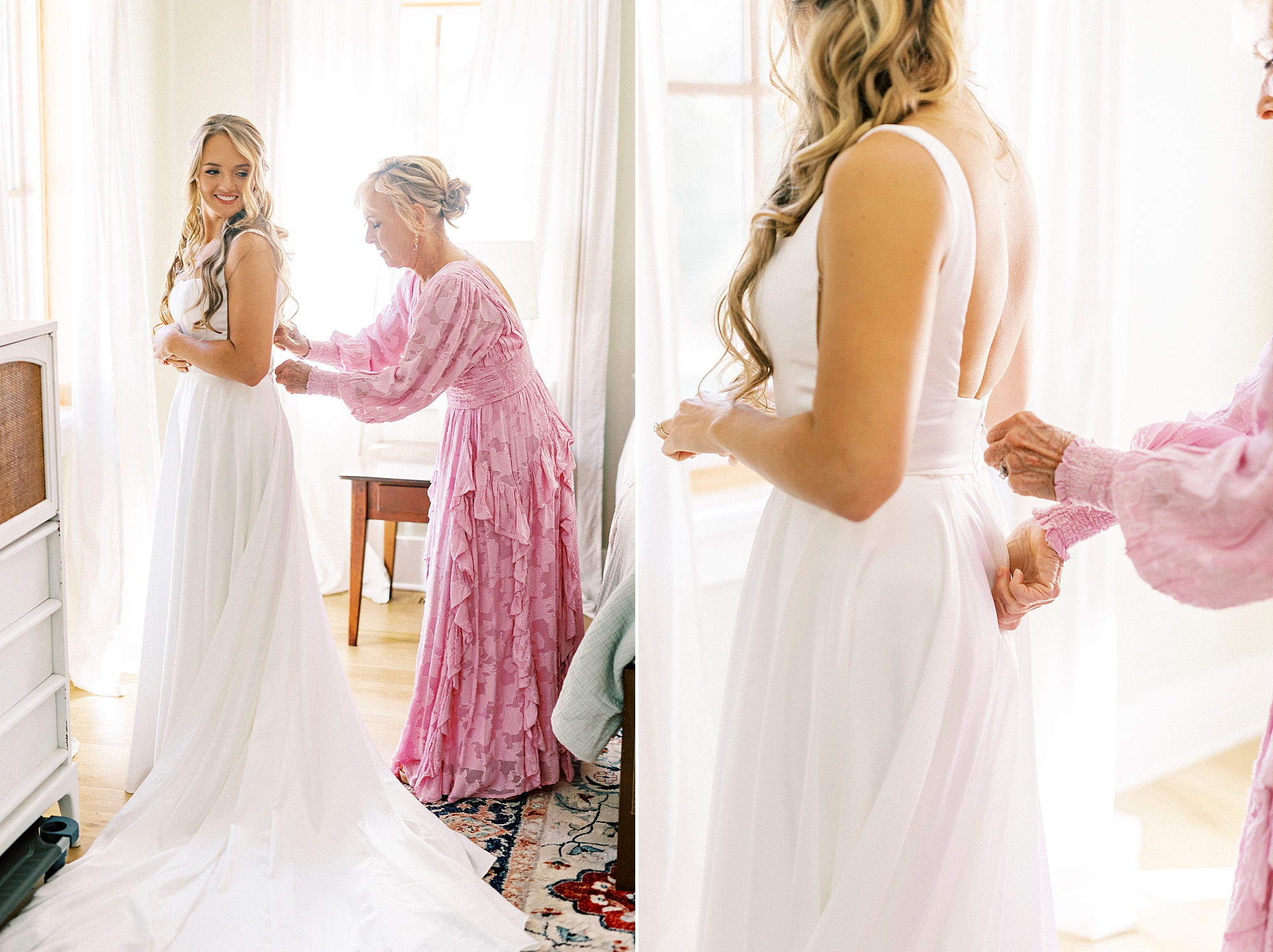 mother in pink dress helps bride into wedding dress
