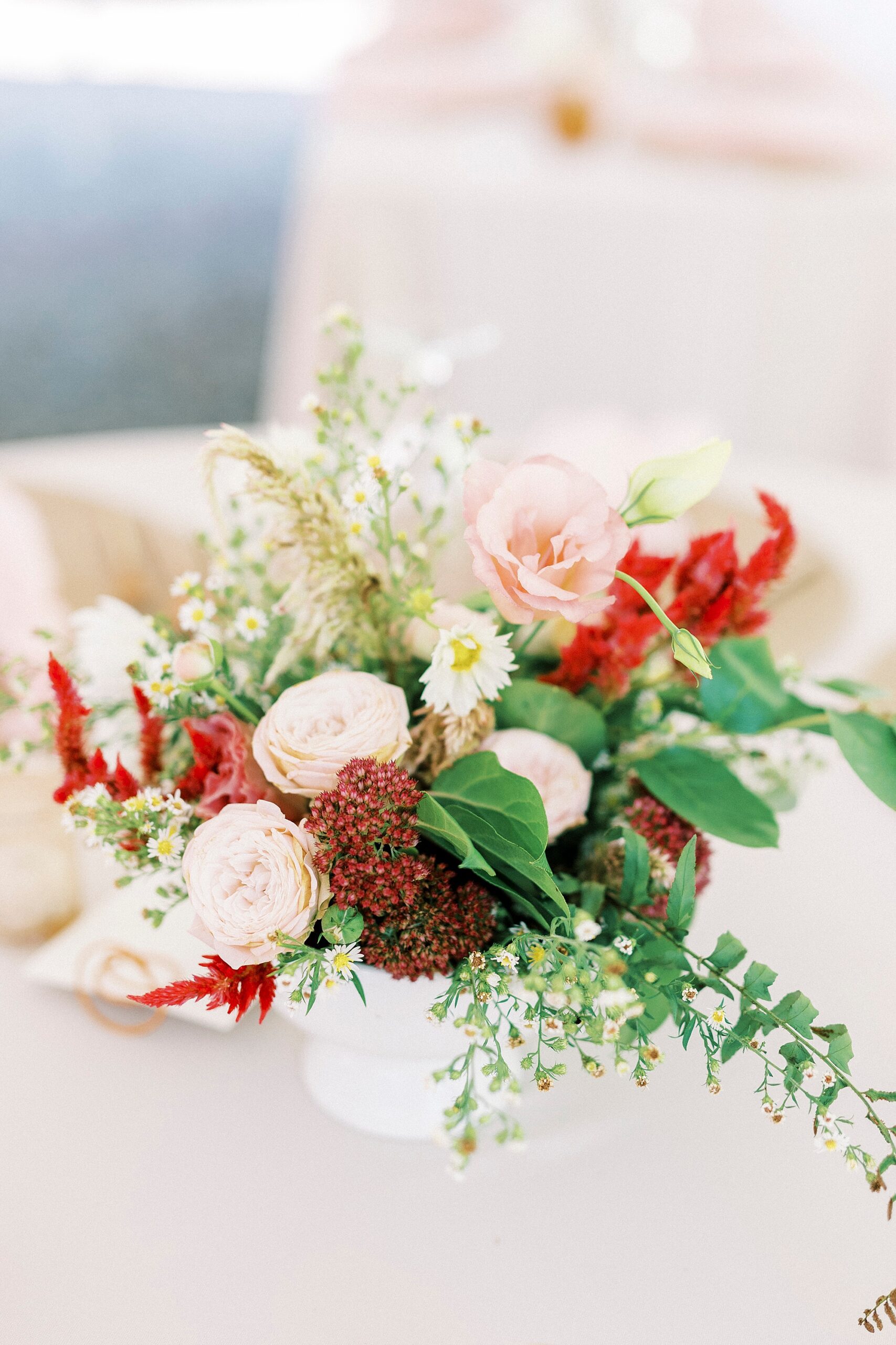 wedding reception with pink and red flowers in centerpiece 