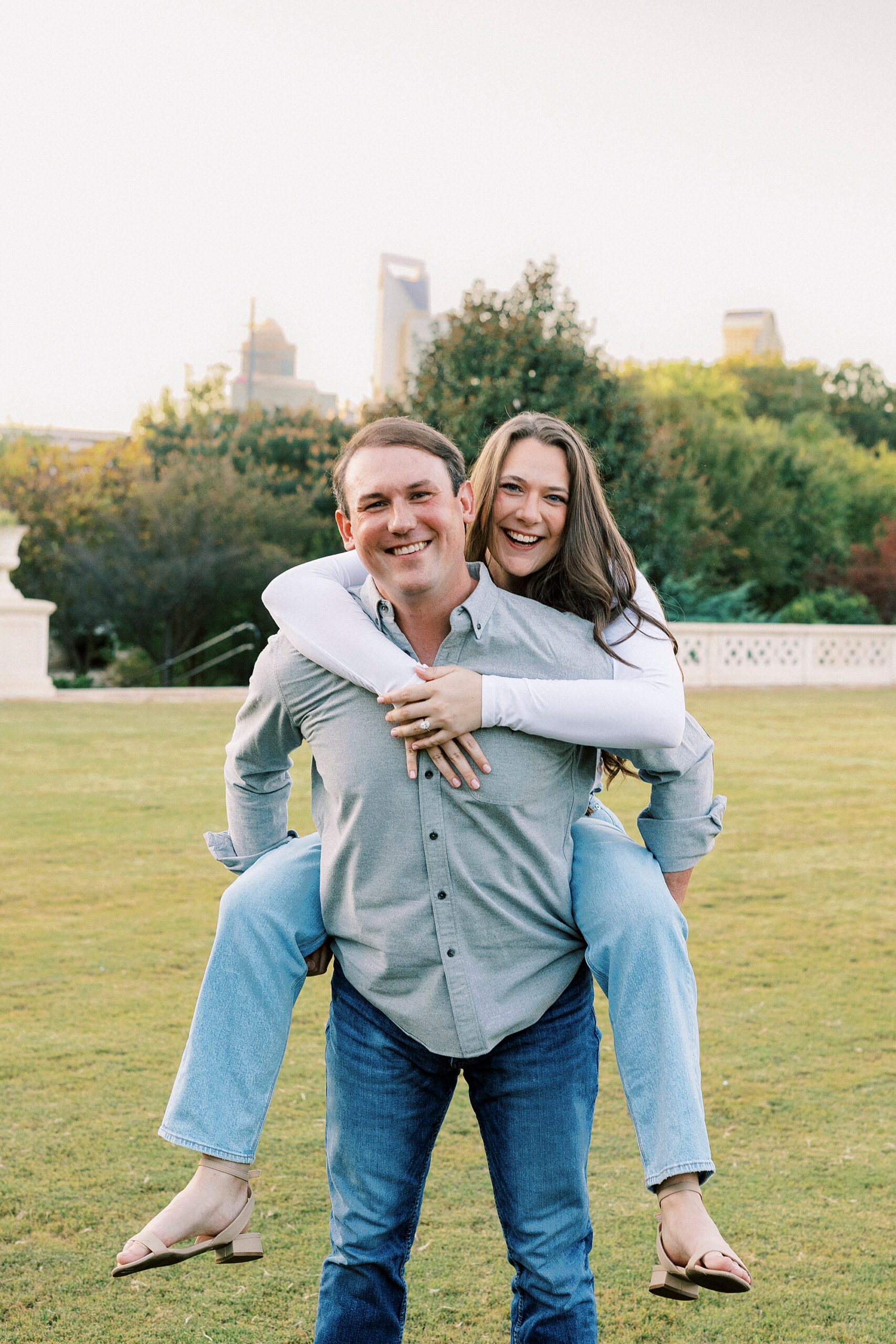 man gives woman piggy back ride through Midtown Park