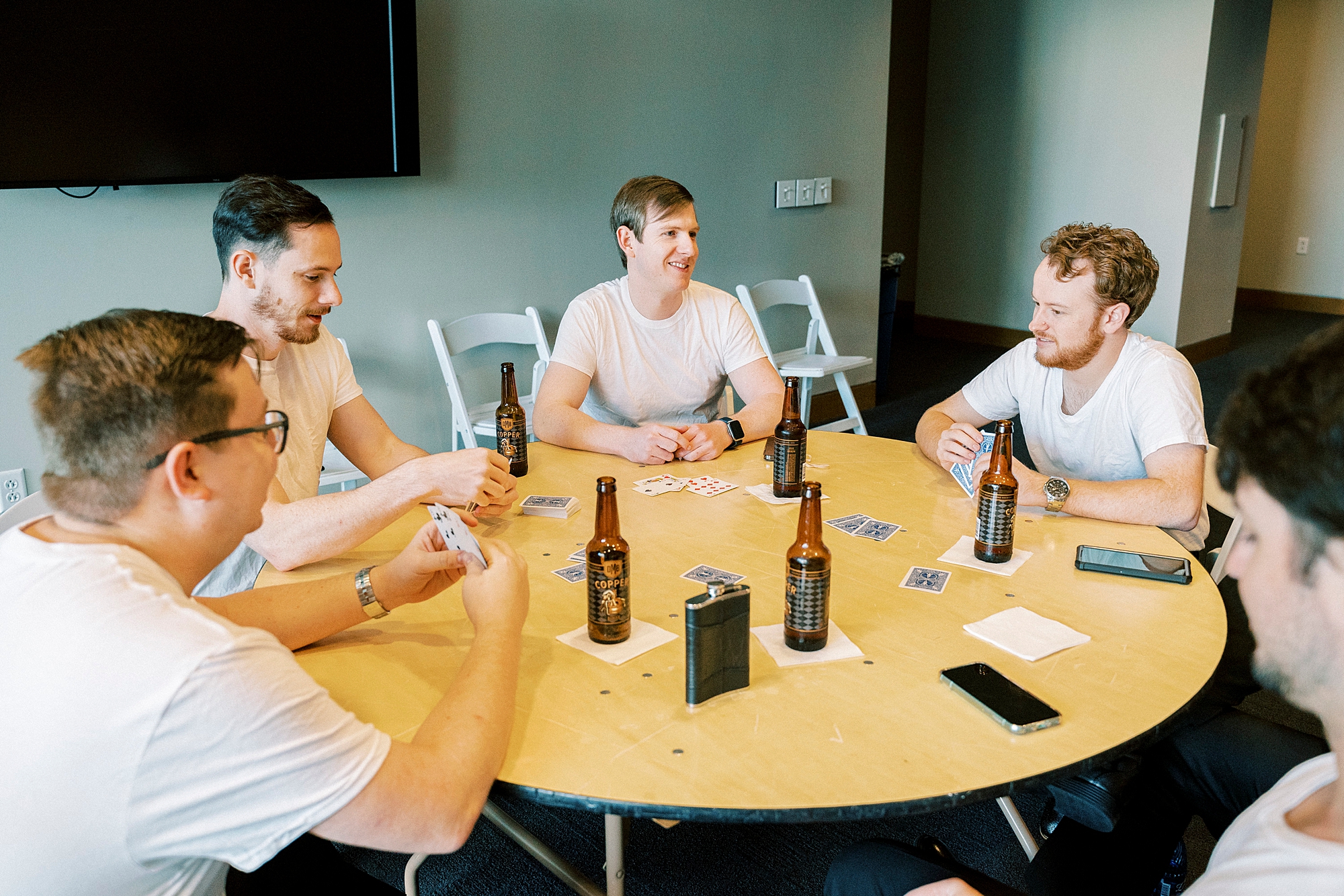 groom and groomsmen have a drink inside the Mint Museum Uptown
