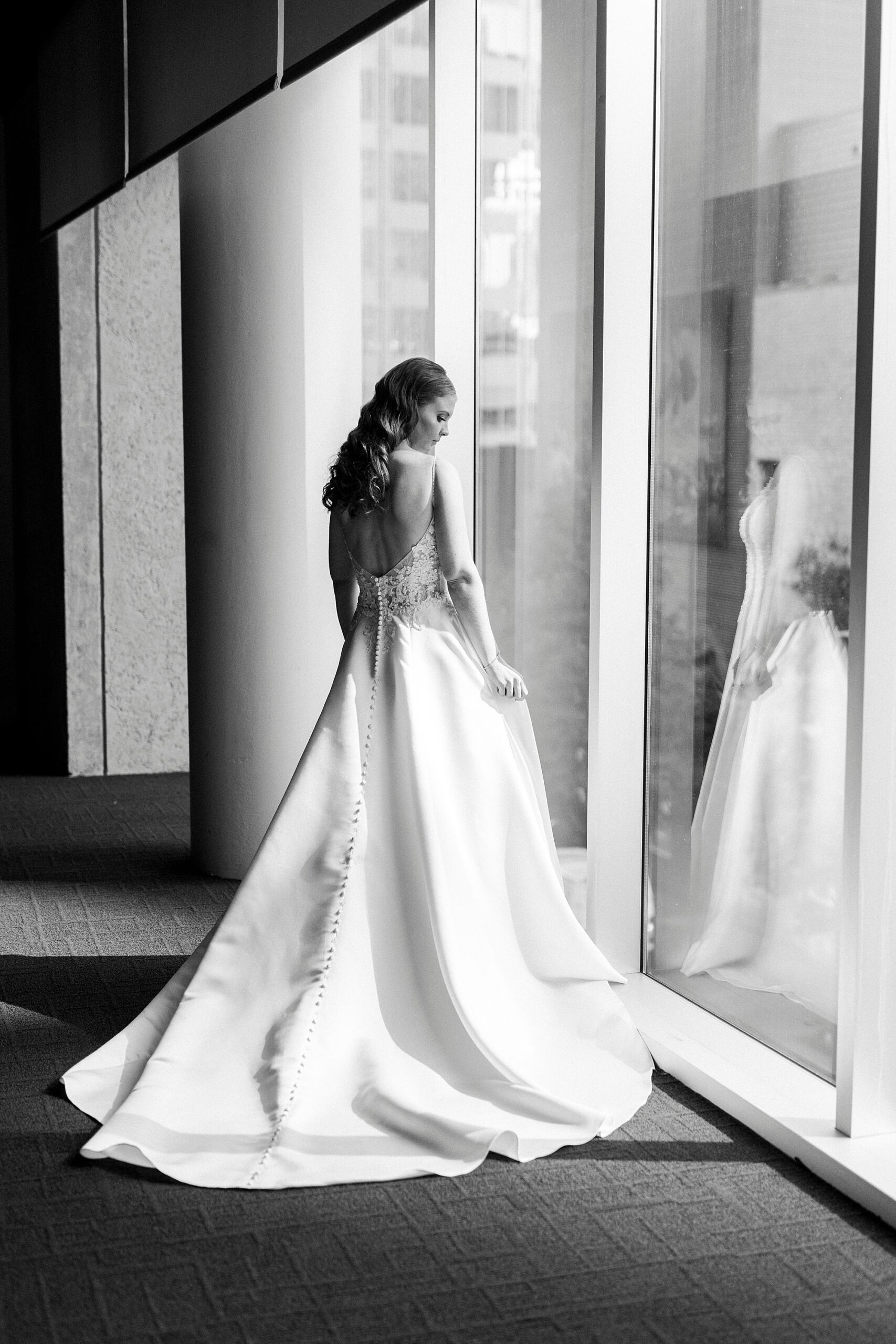 bride stands in window at the Mint Museum Uptown
