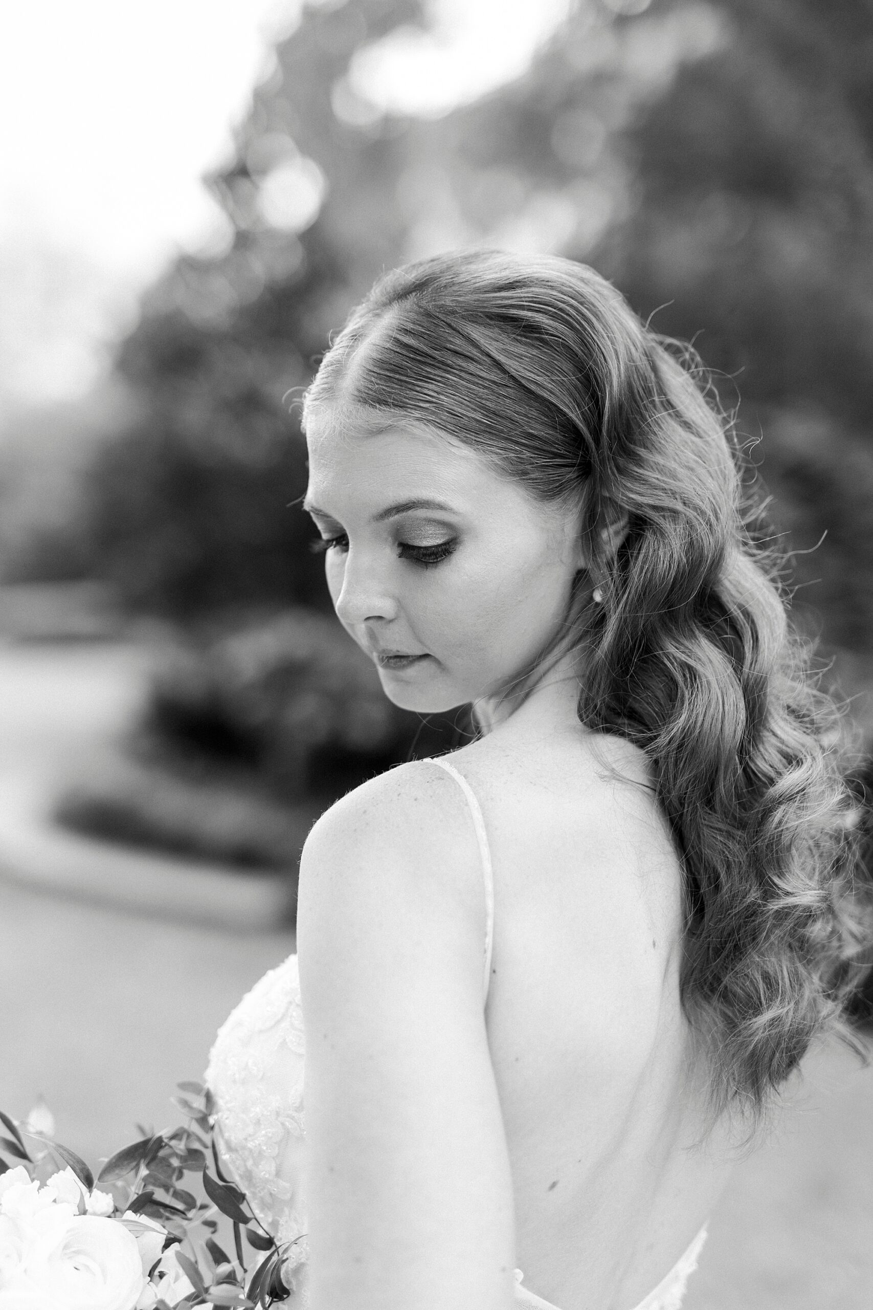 bride looks over shoulder in strapless wedding gown