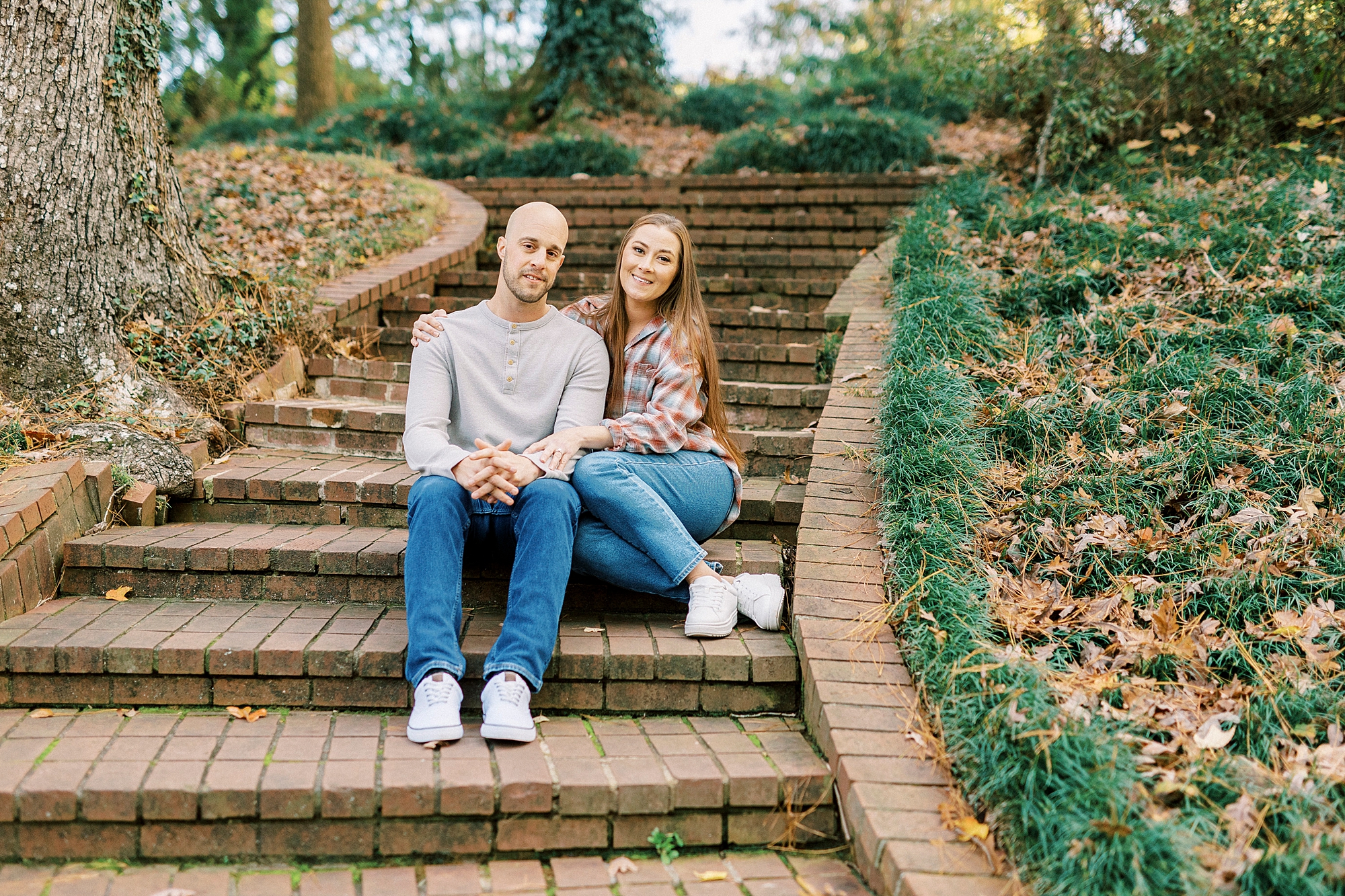 man and woman sit on steps inside Rock Hill SC park